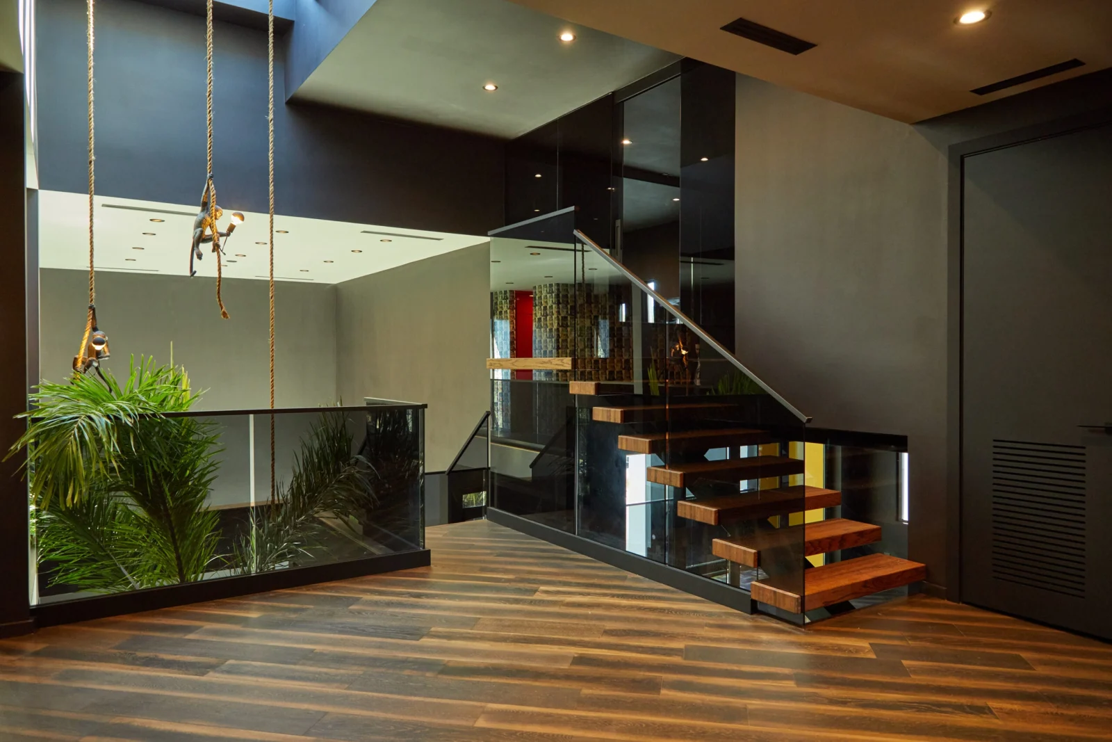 Room view with the flight at right and glass railing wrapping the planter