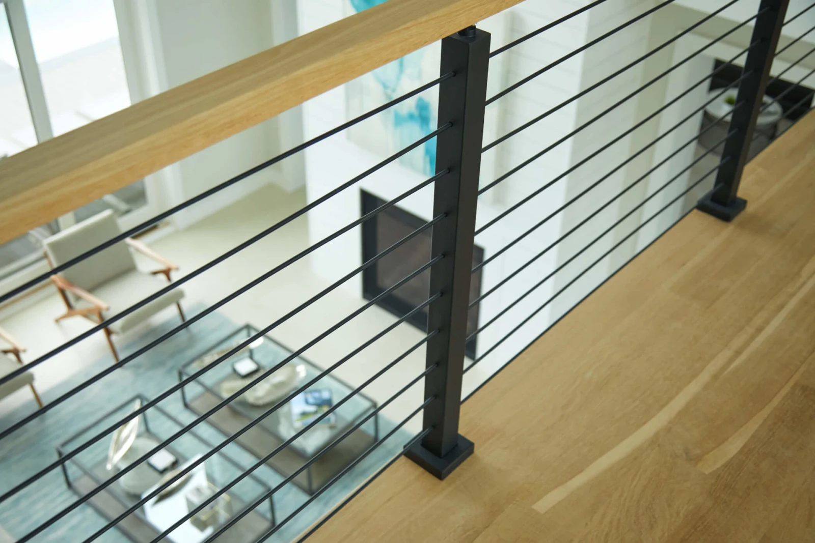 Overlook railing detail with a black post and wood top rail above seating