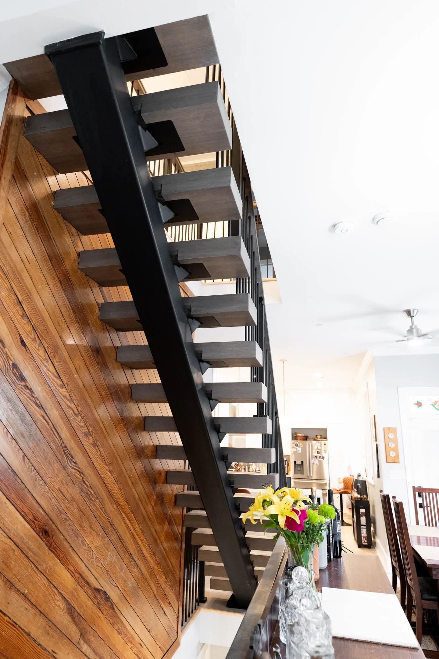 Looking up the flight with the black stringer against the plank wall