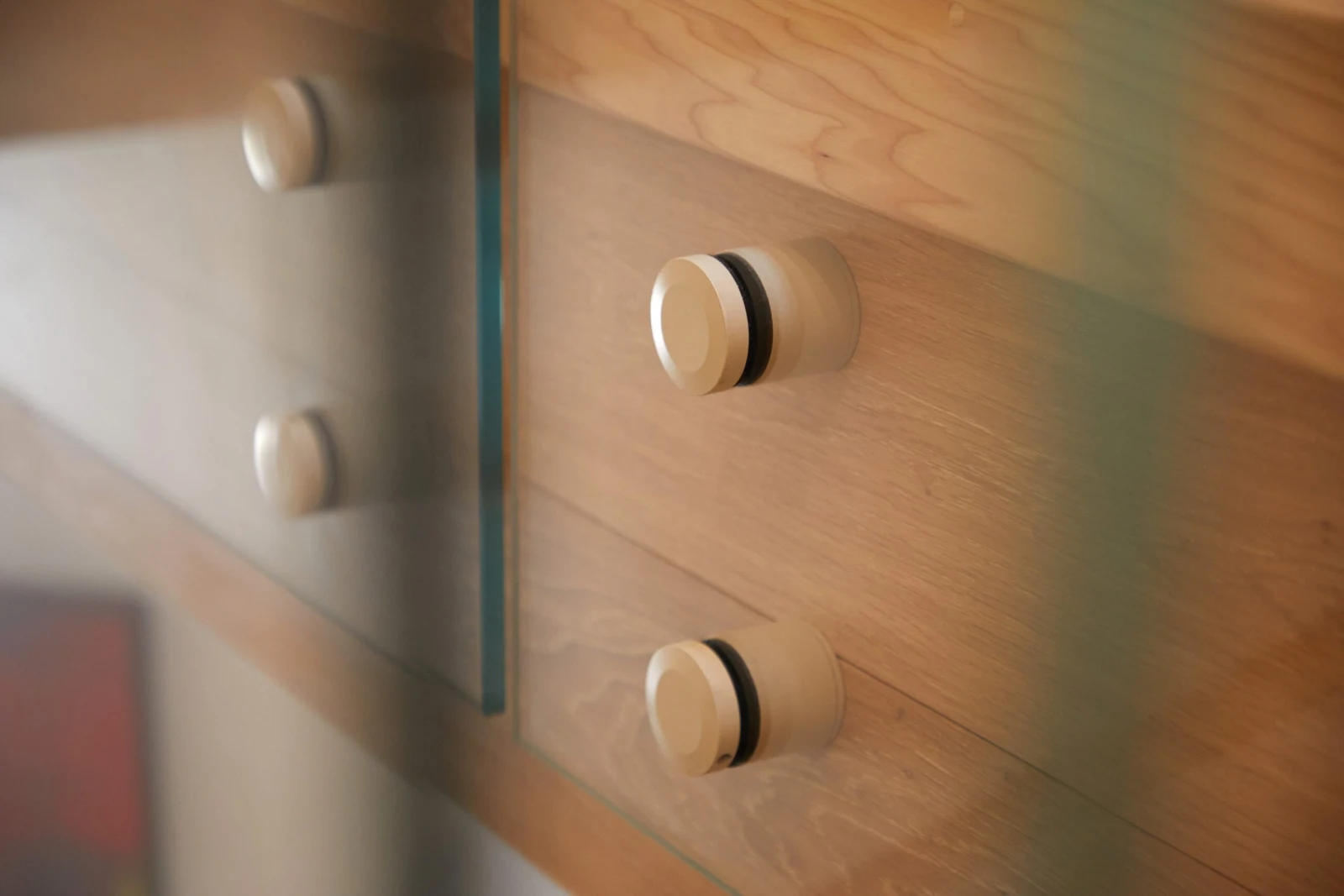 Close detail of round standoff pins securing glass to the stair fascia