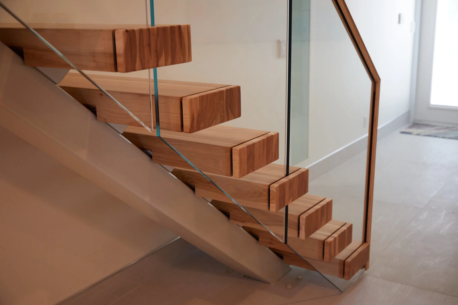 Angled view of stepped tread ends behind a single sheet of glass
