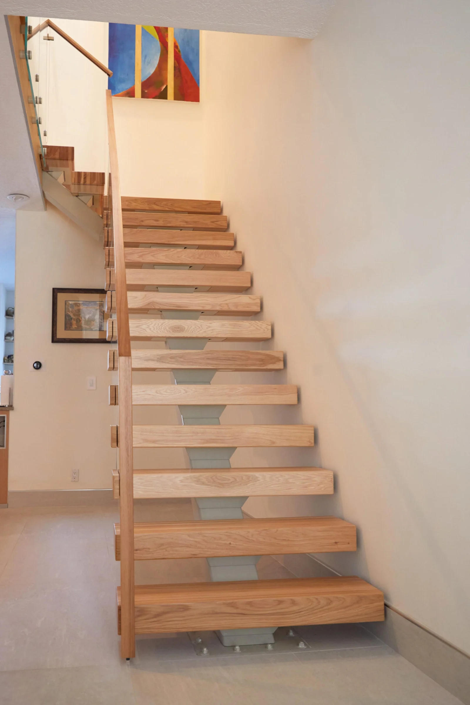 Straight-on view up the full flight of open-riser treads on a center stringer