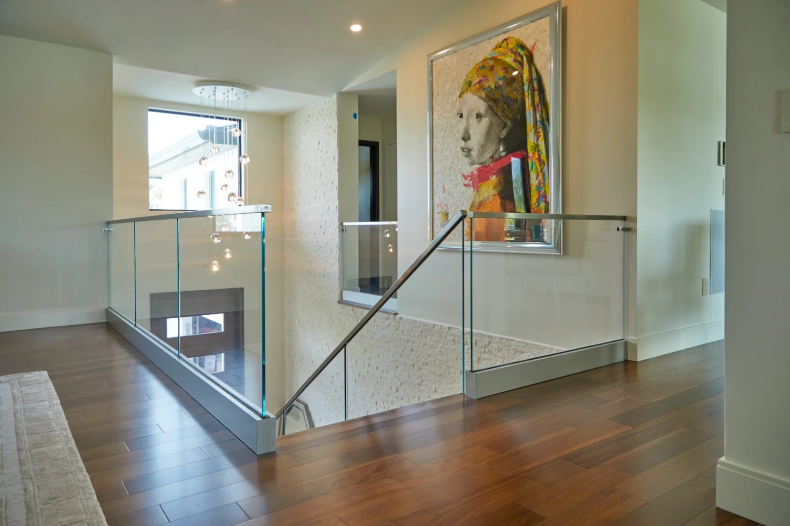 Upper balcony run of glass railing set in a metal base shoe
