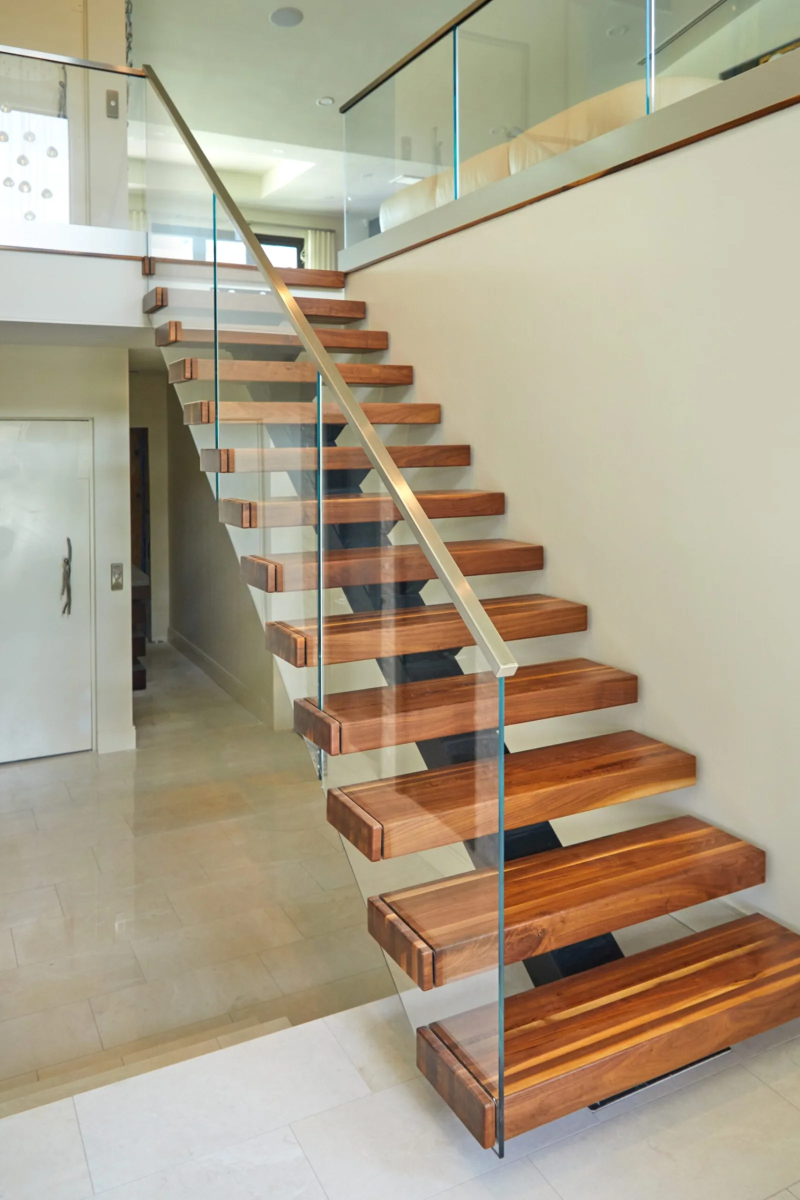 Full flight viewed head-on with glass infill and a slender handrail above