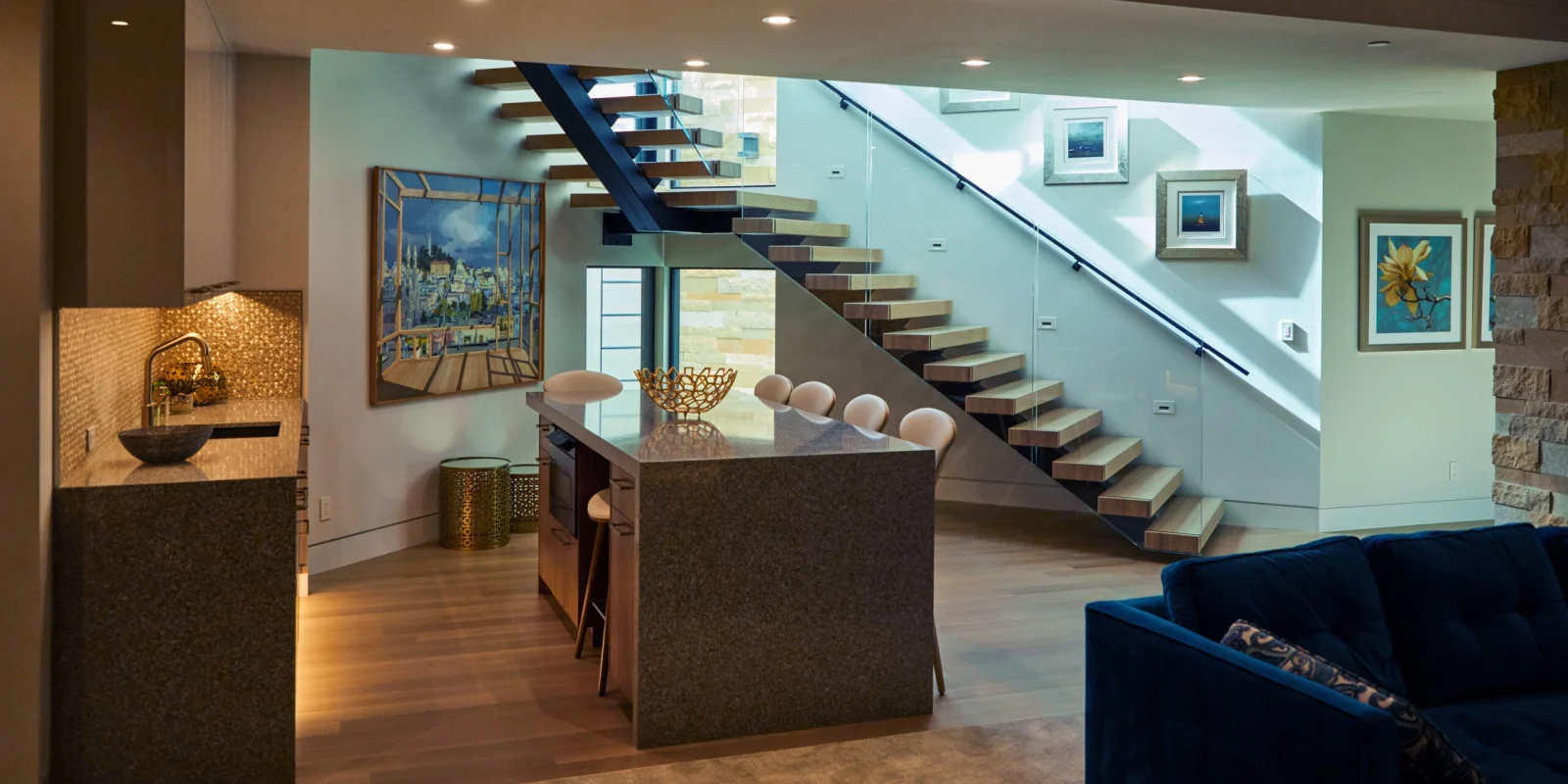 Lower level living space with the stair descending on a dark stringer