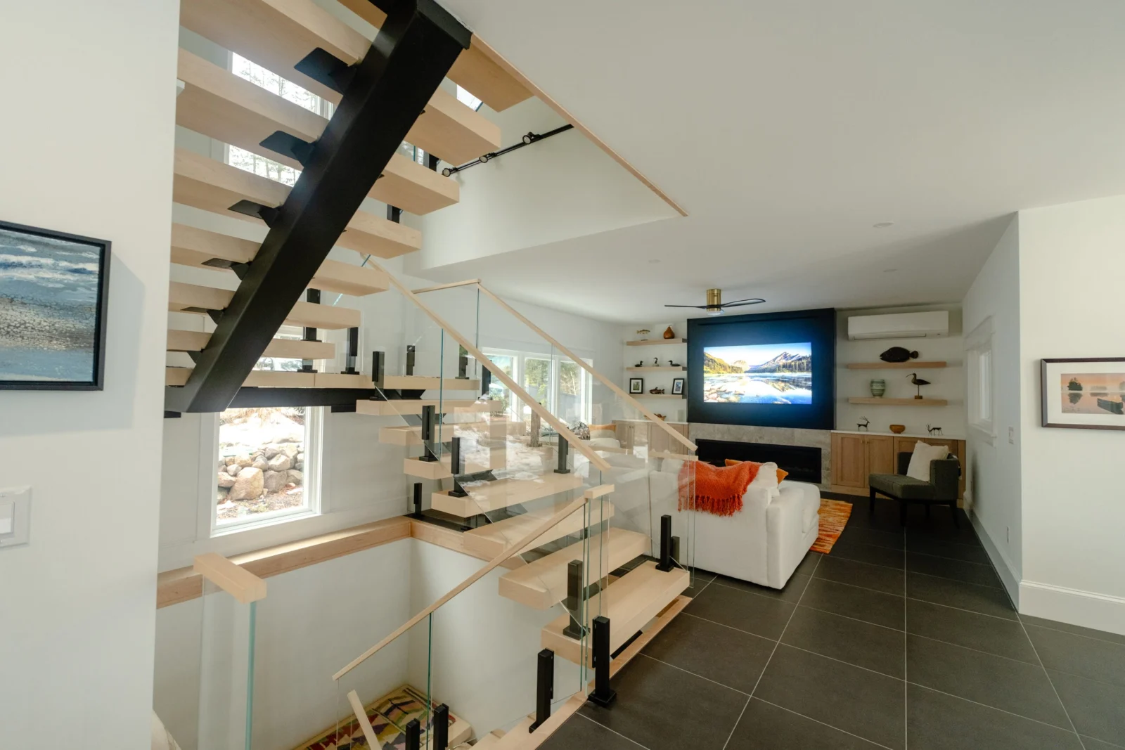 Open two-level view of the stair and glass-railed landing