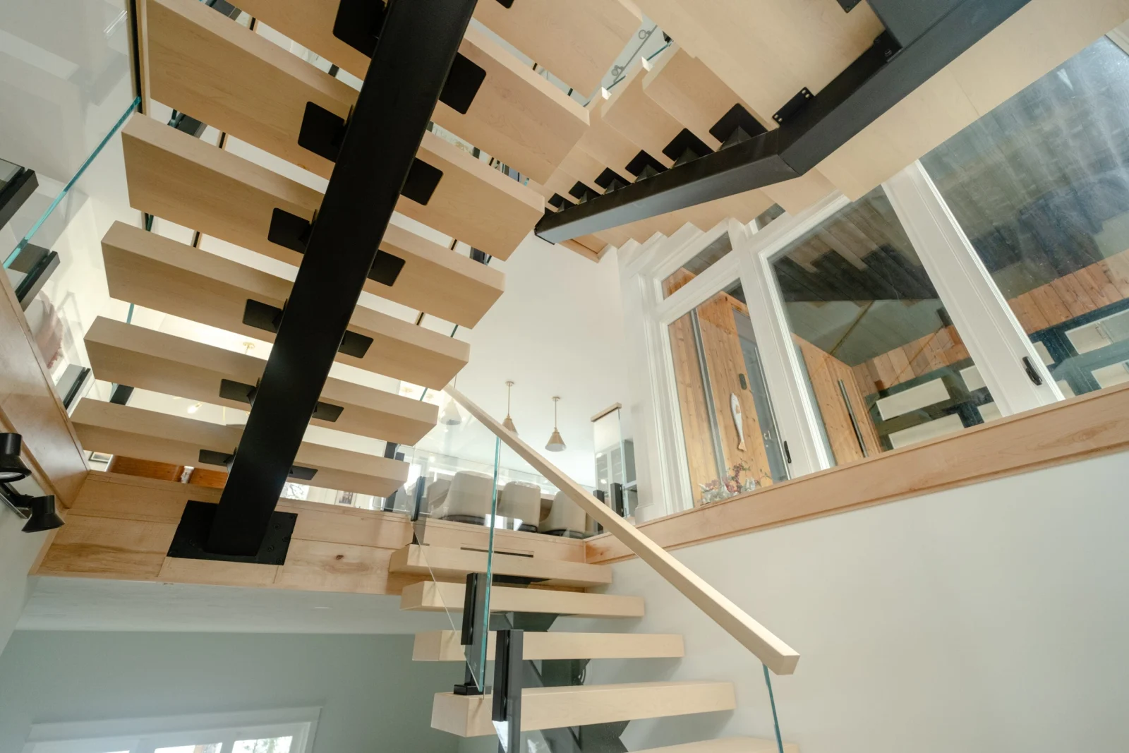 Upward view beneath the upper run past glass railing and window