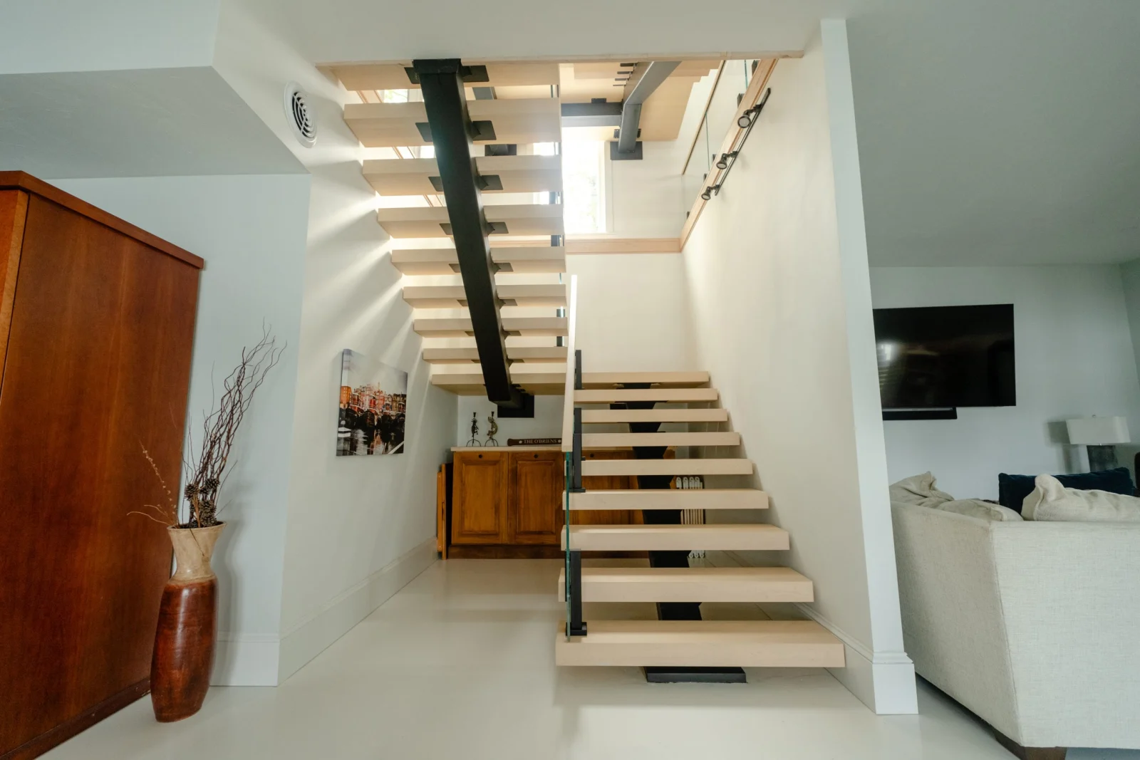 Stair rising through the living space on a black stringer