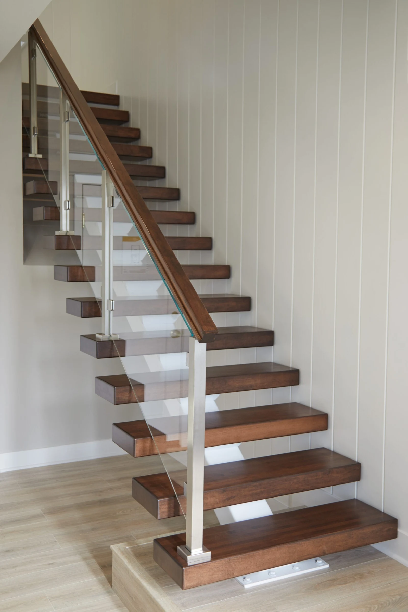 Full elevation of the single stringer stair with glass infill and wide bottom tread