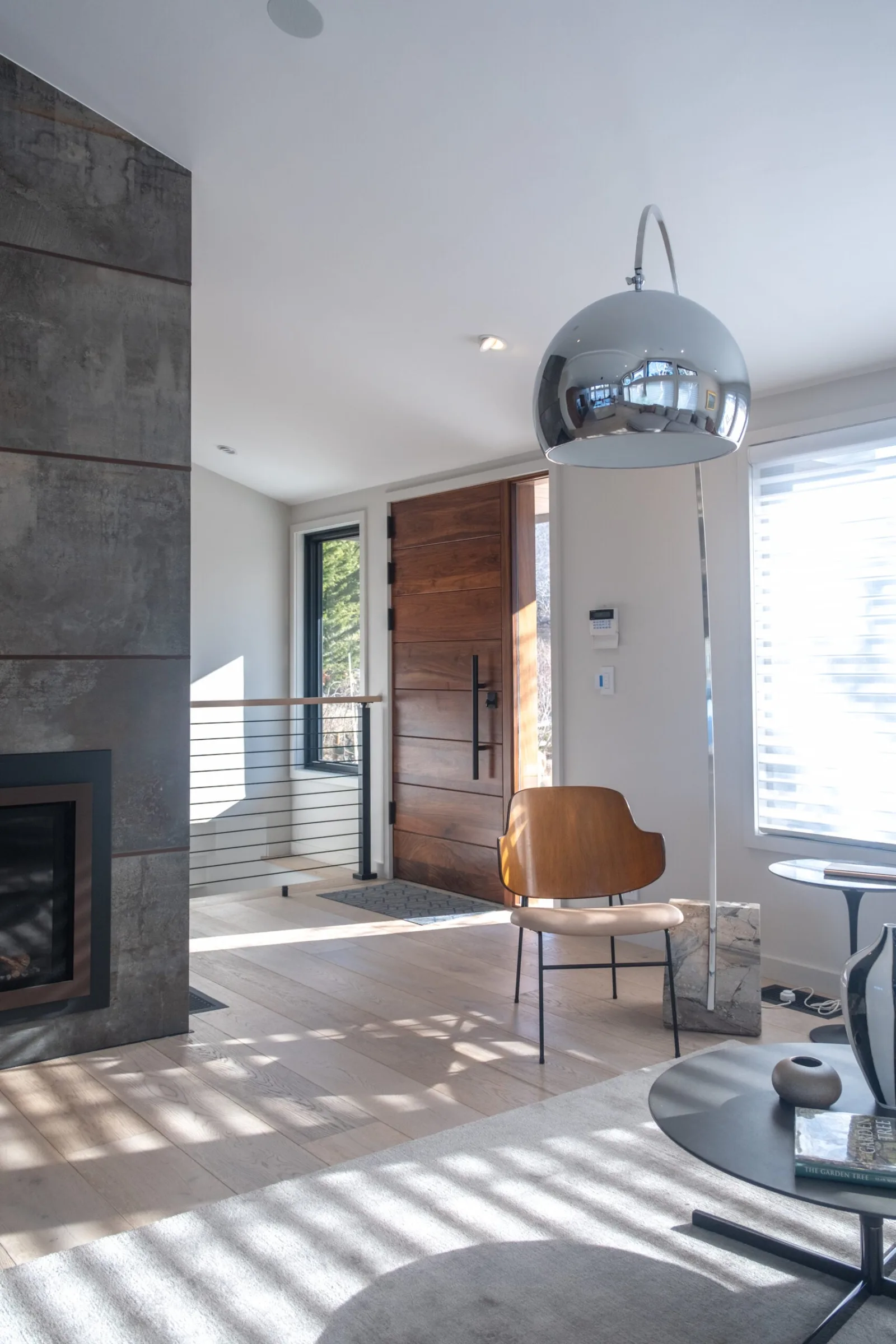 Living space with a tiled fireplace and the rod railing visible near the entry