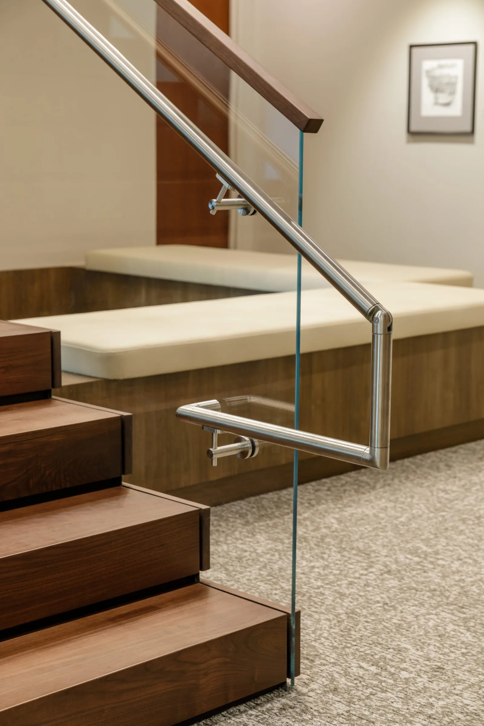 Base of the glass railing where the treads meet a built in bench