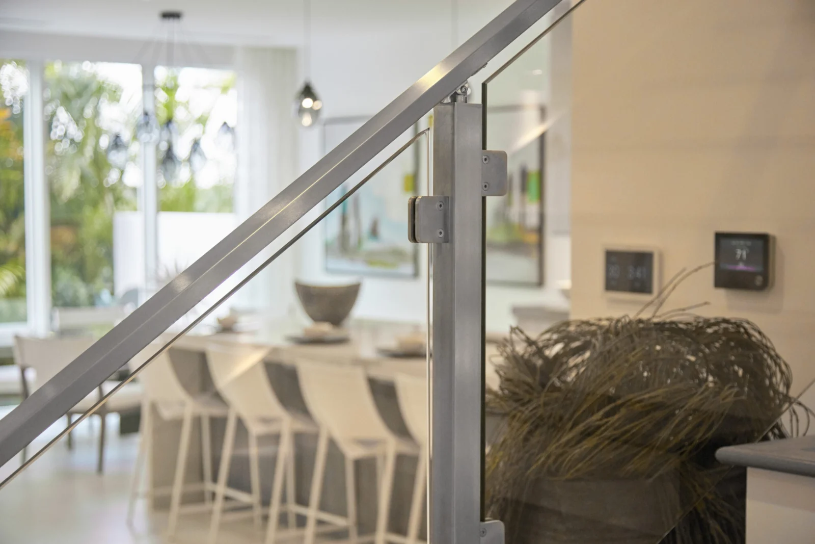 Post and clamp detail in focus with a dining counter blurred beyond the glass