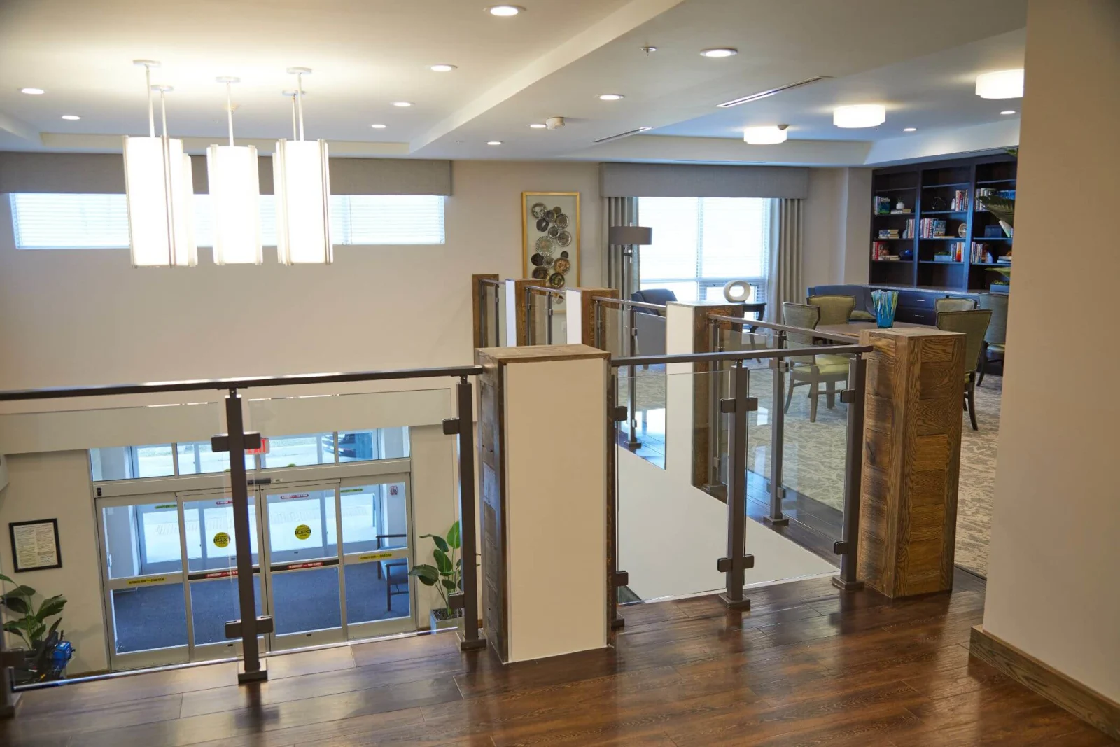 Railing wrapping a mezzanine opening with the entry lobby visible far below
