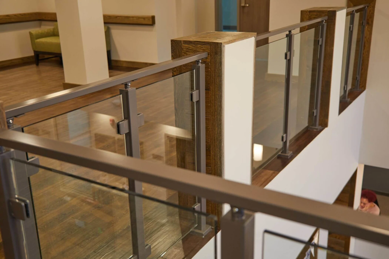 Looking down the top rail as it passes a timber-clad newel post