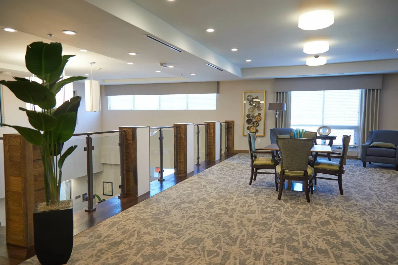 Wide room view with the railing guarding a stairwell opening at left