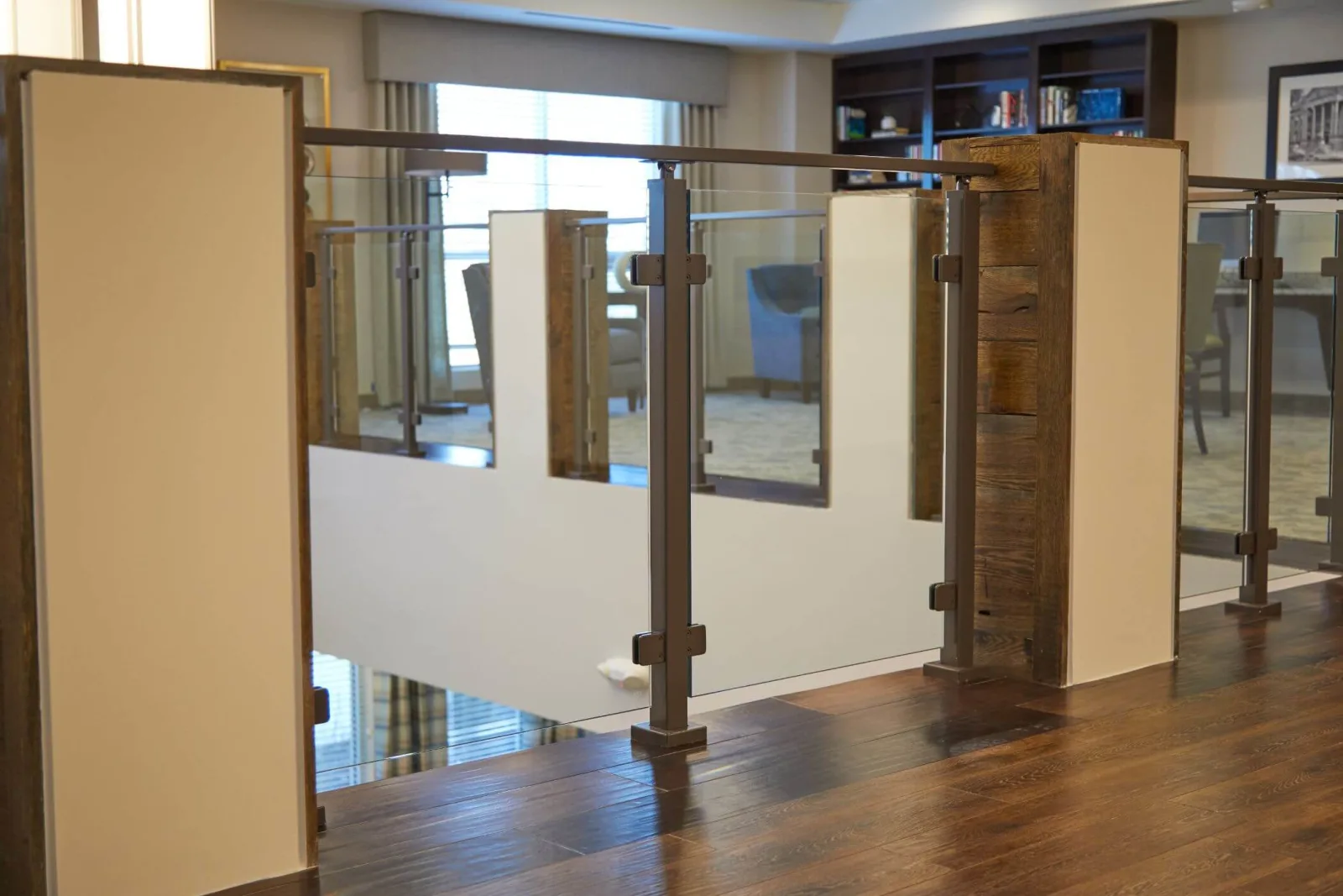 Glass panels alternating with solid infill along a second-floor walkway