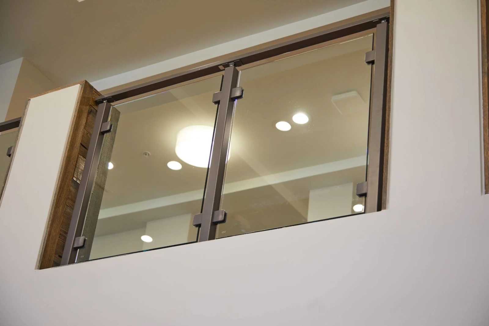 Two glass panels filling a framed opening in the balcony wall
