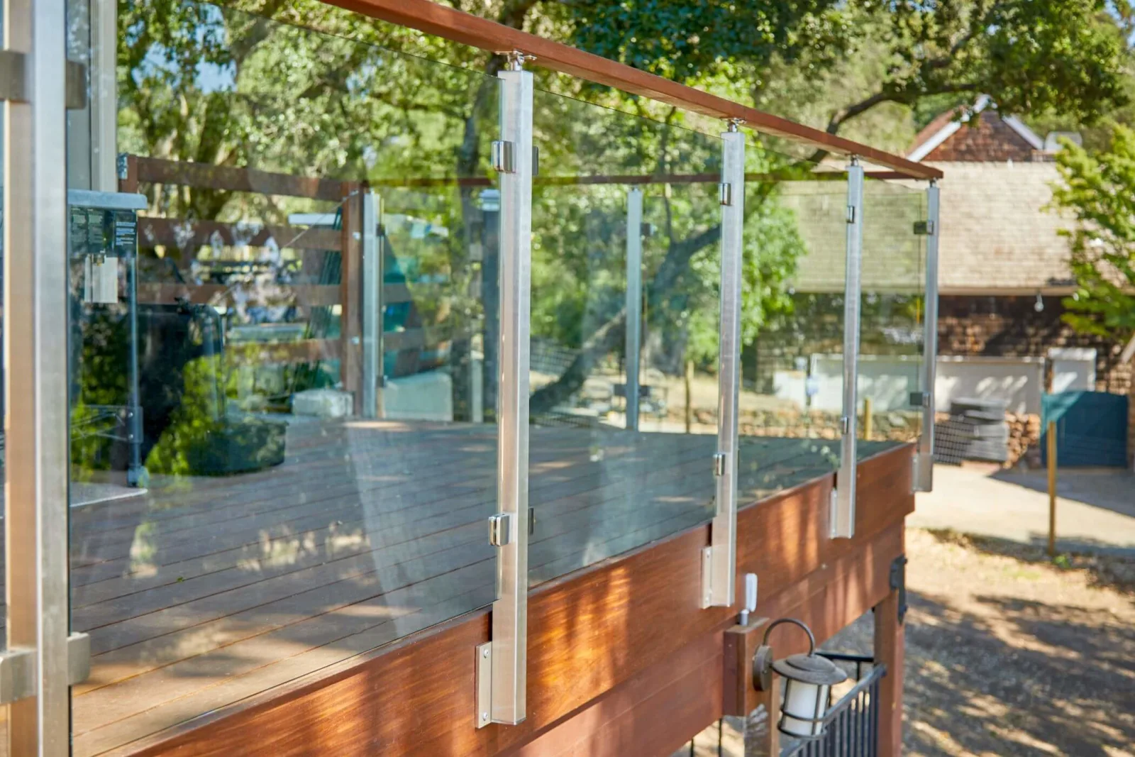 Railing seen from outside the deck with posts rising from the wood fascia