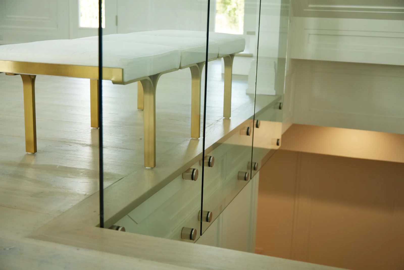 Bench beside the stairwell opening guarded by glass on polished standoffs