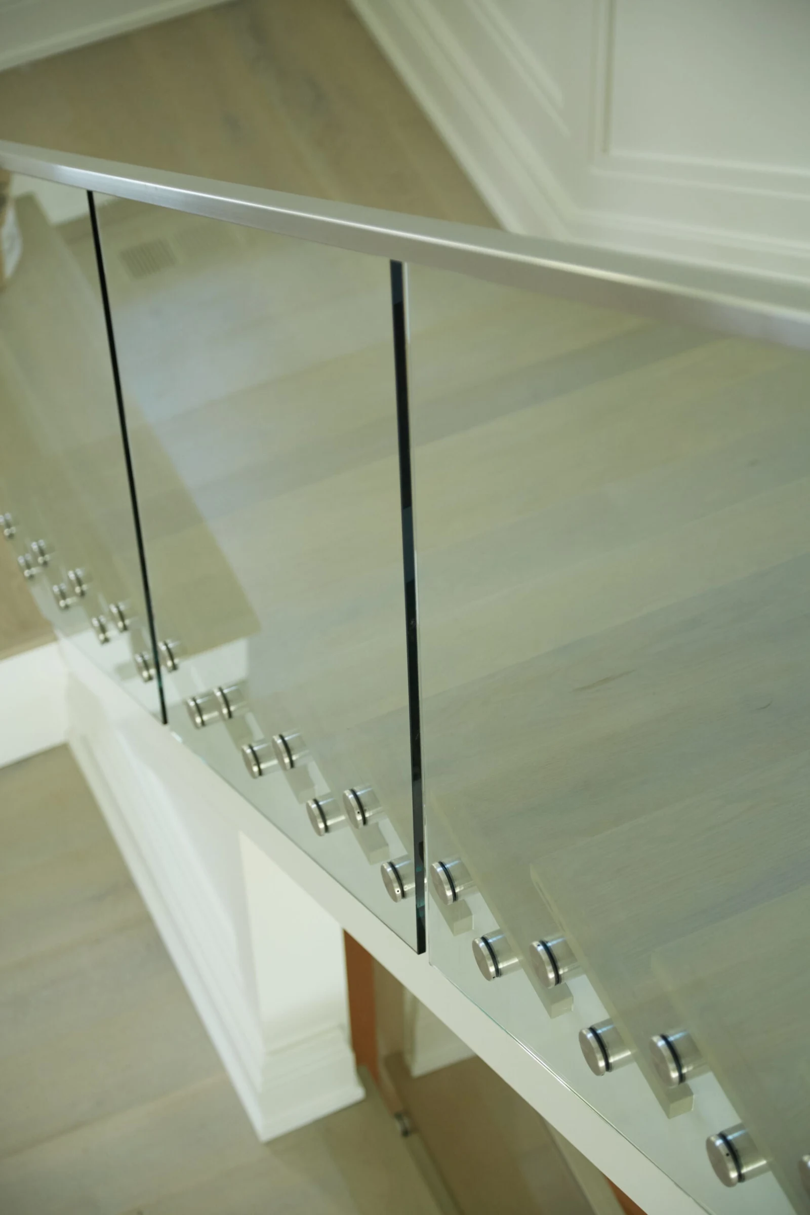 Looking down over the top rail at the flight descending behind glass