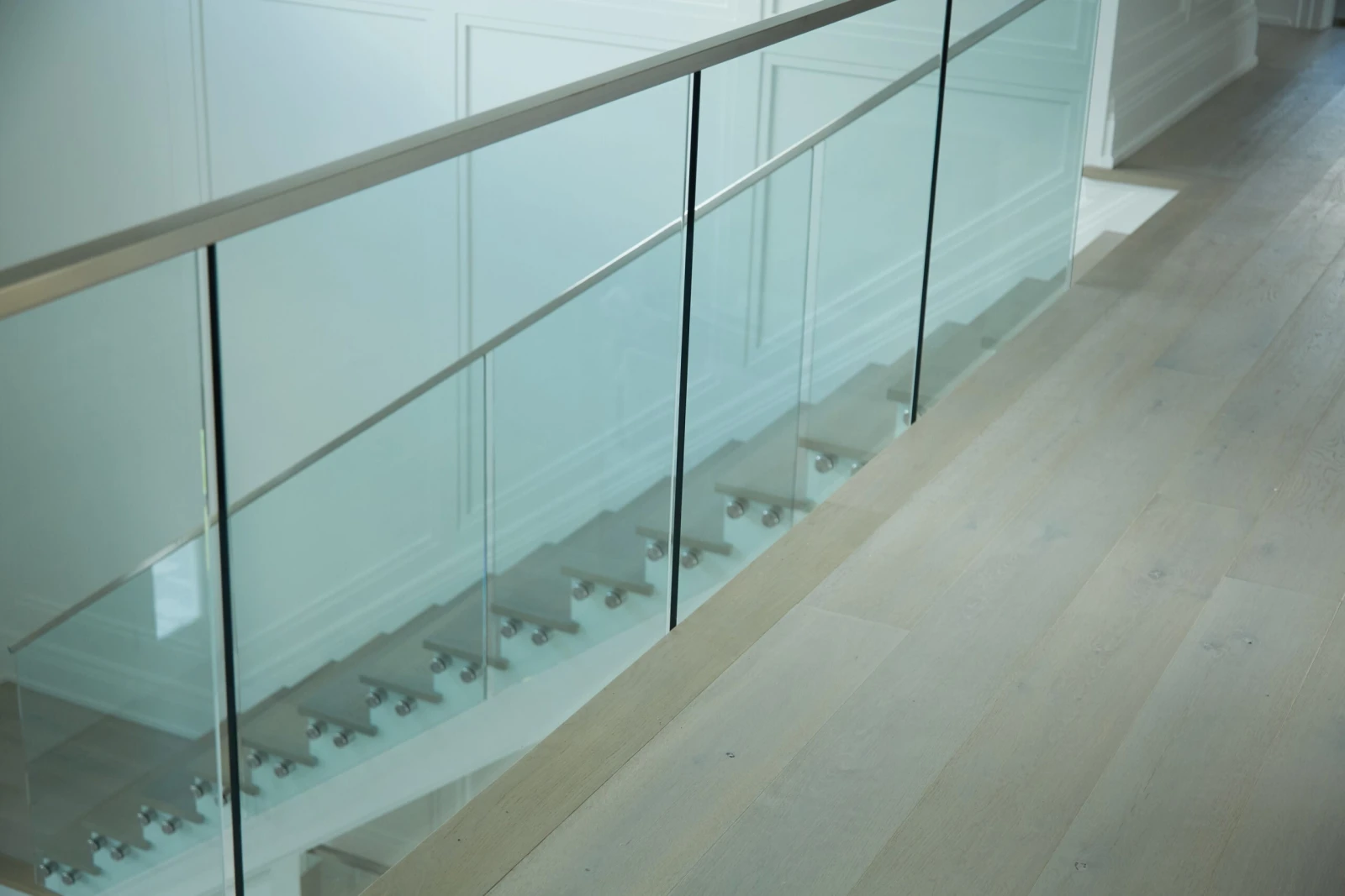 Railing along a landing edge with the stair dropping away beyond it