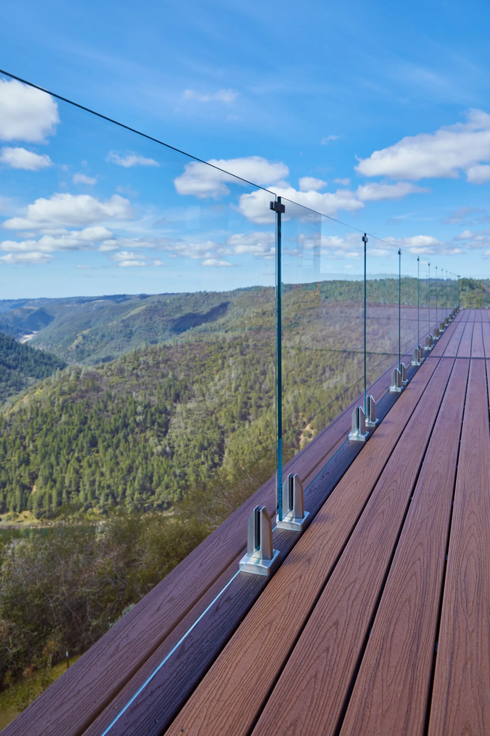 Looking down the railing line as glass panels follow the deck's long edge