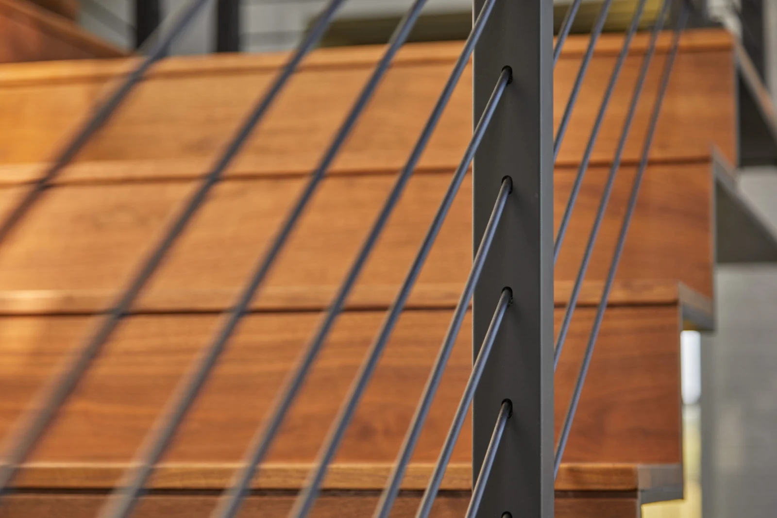 Tight detail of post and angled rods above a wood landing