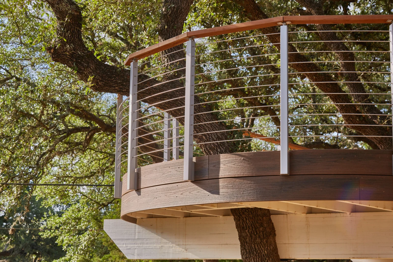 Rounded deck corner seen from outside, fascia curving below the railing line