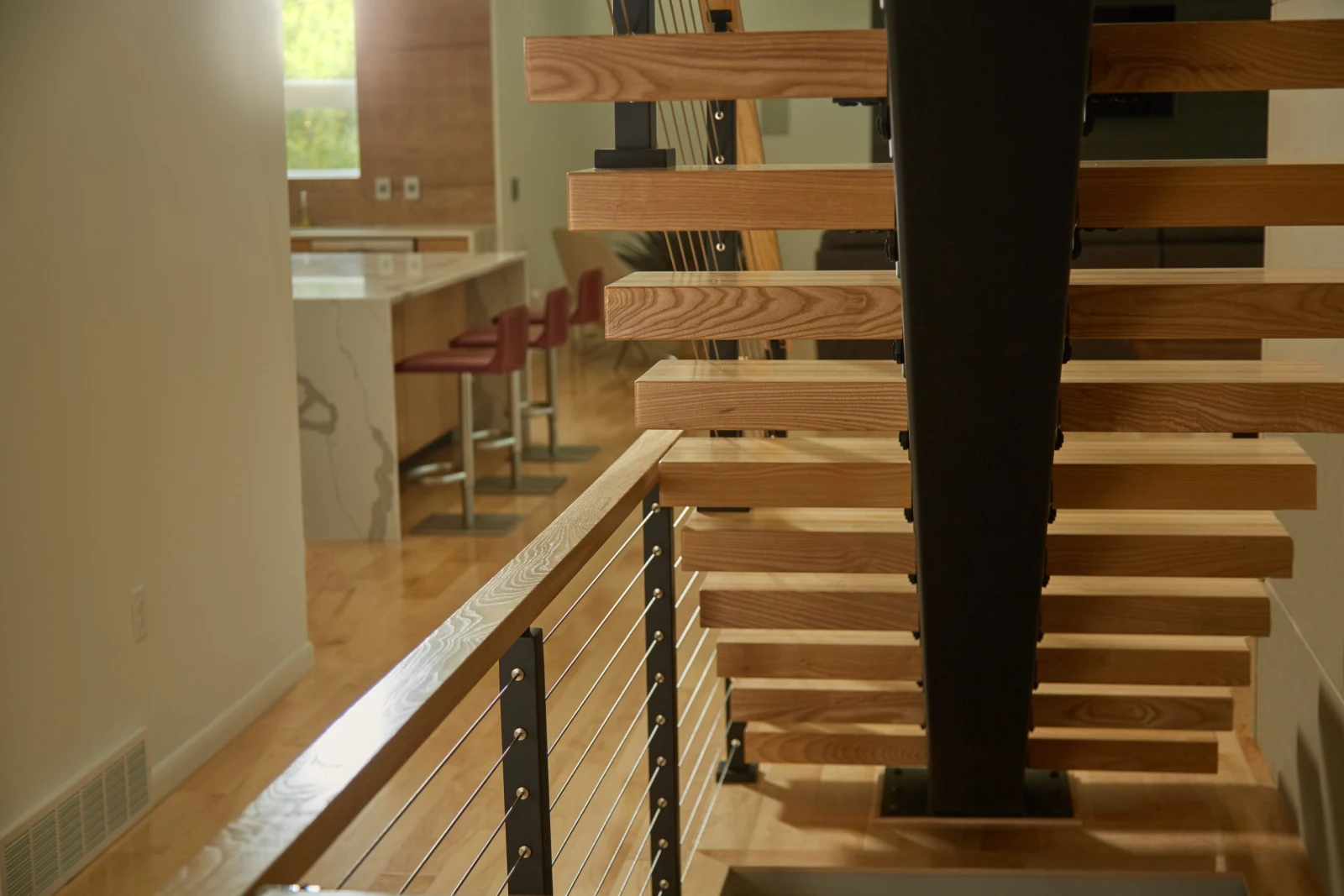 View up the flight past the center stringer toward the kitchen beyond