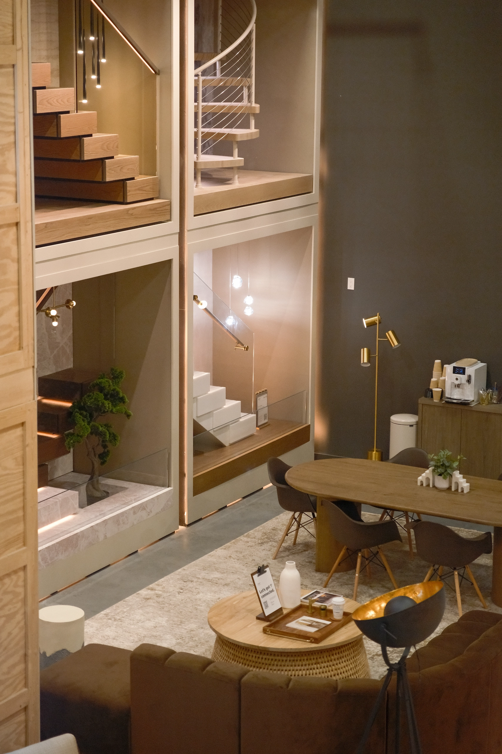 Stair displays rise above a styled dining vignette in a showroom