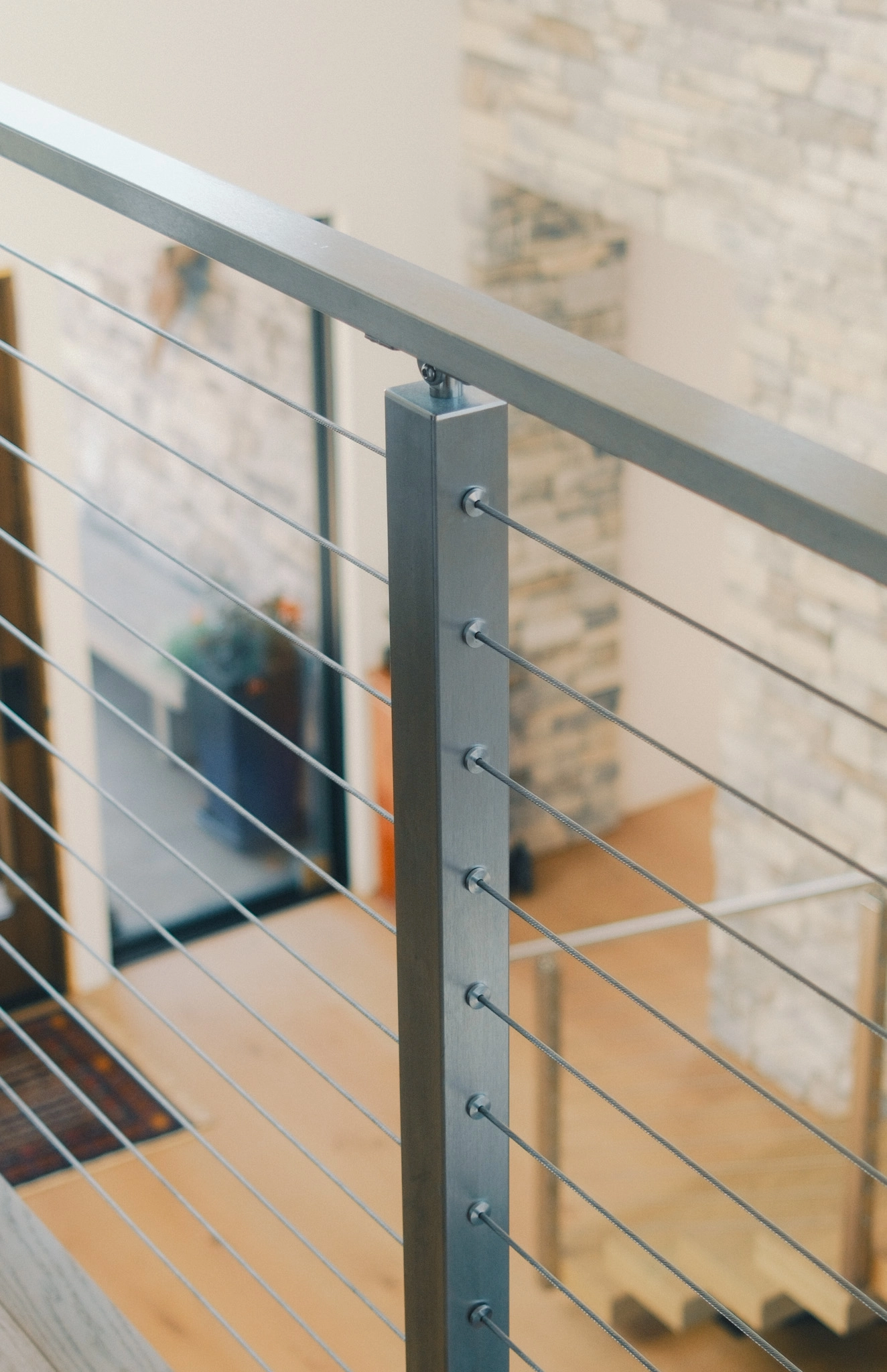 Brushed stainless post with flat top rail and evenly spaced cable runs
