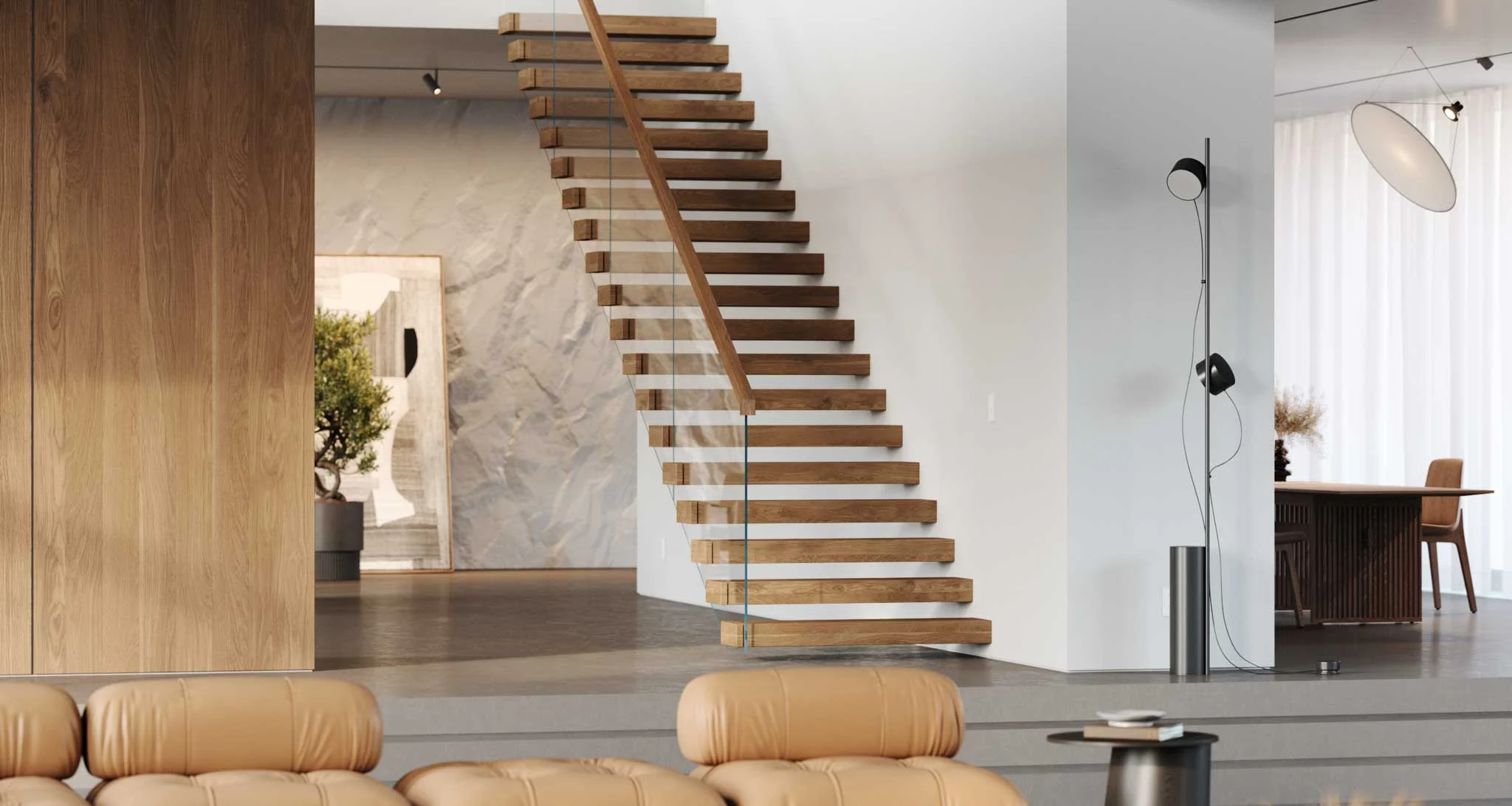Cantilevered treads climb a bright room behind glass panels and a wood handrail