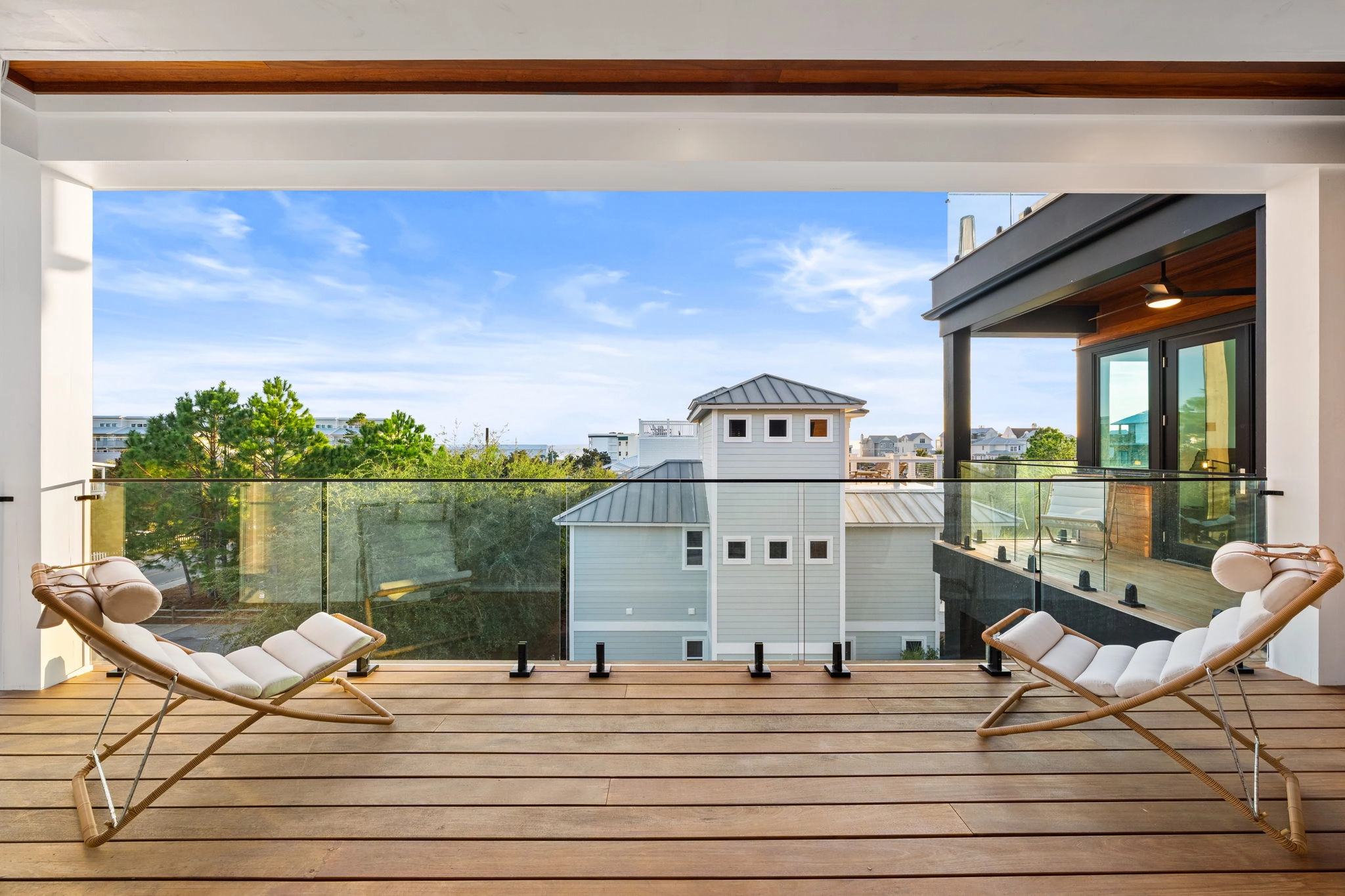 Glass panels in low spigots open a beachfront deck to the water view
