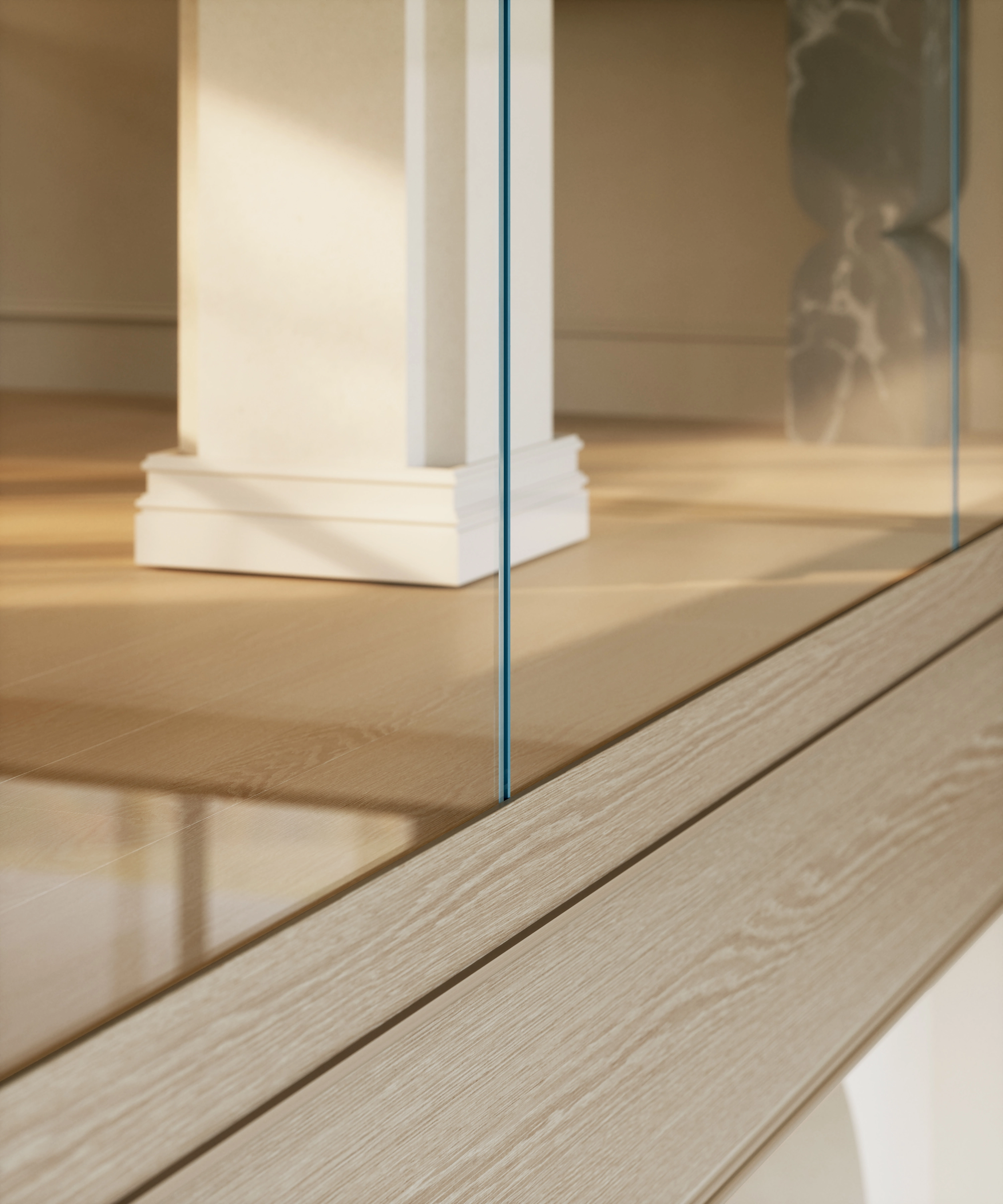 A glass panel meets the floor line beside a column with no bracket in sight