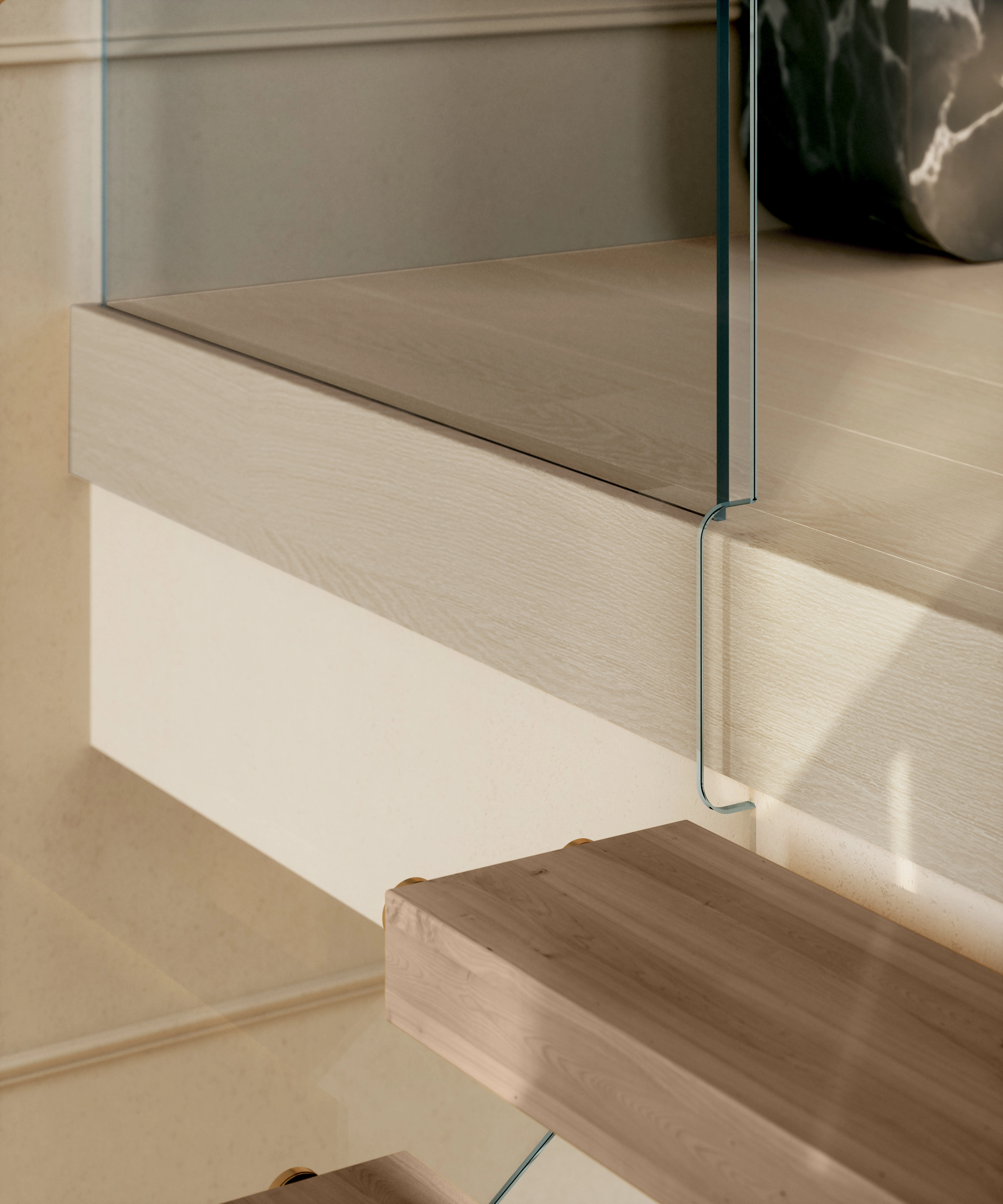 Close-up of a glass panel rising from the floor edge with no visible bracket