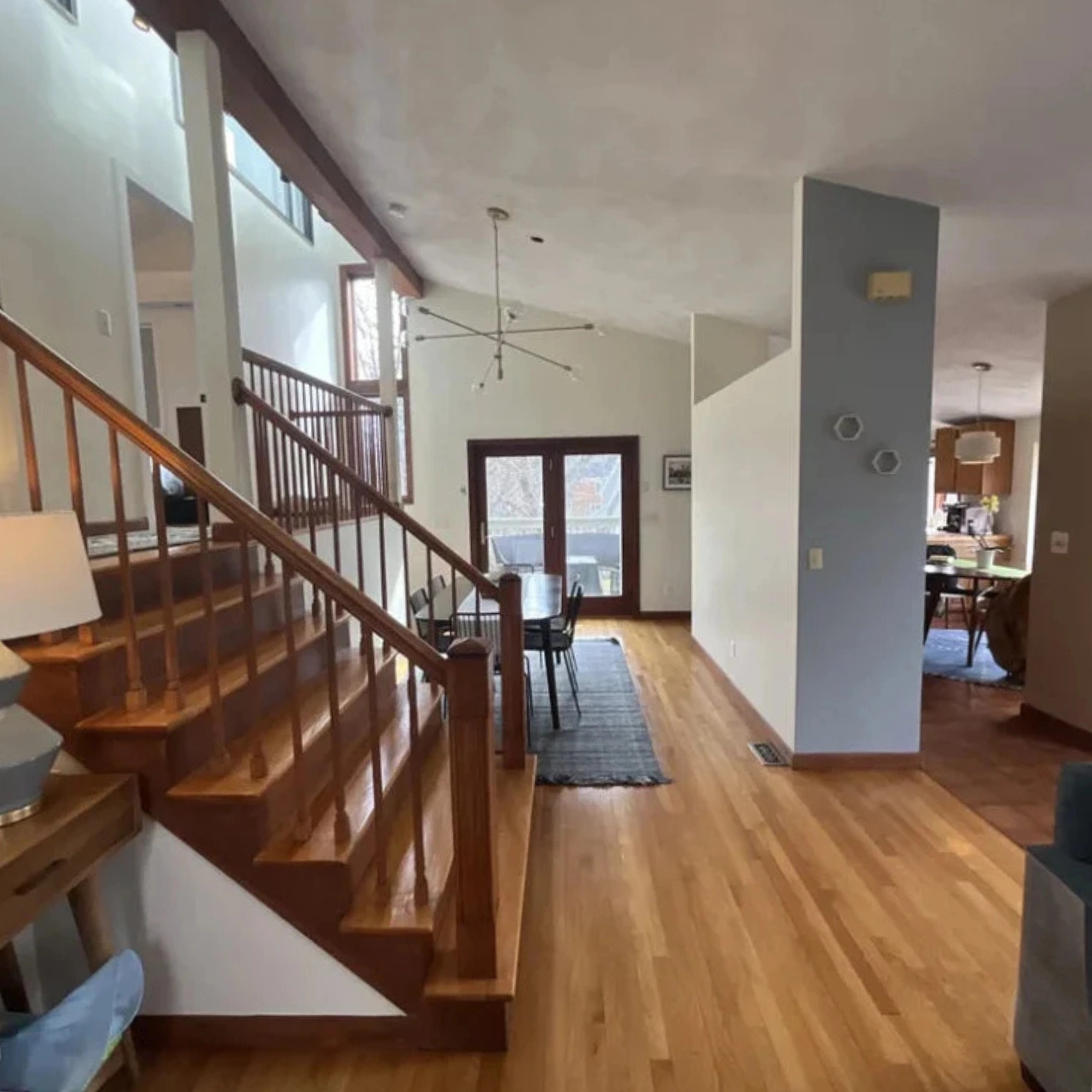 Before: an enclosed wood staircase and half wall in the original interior