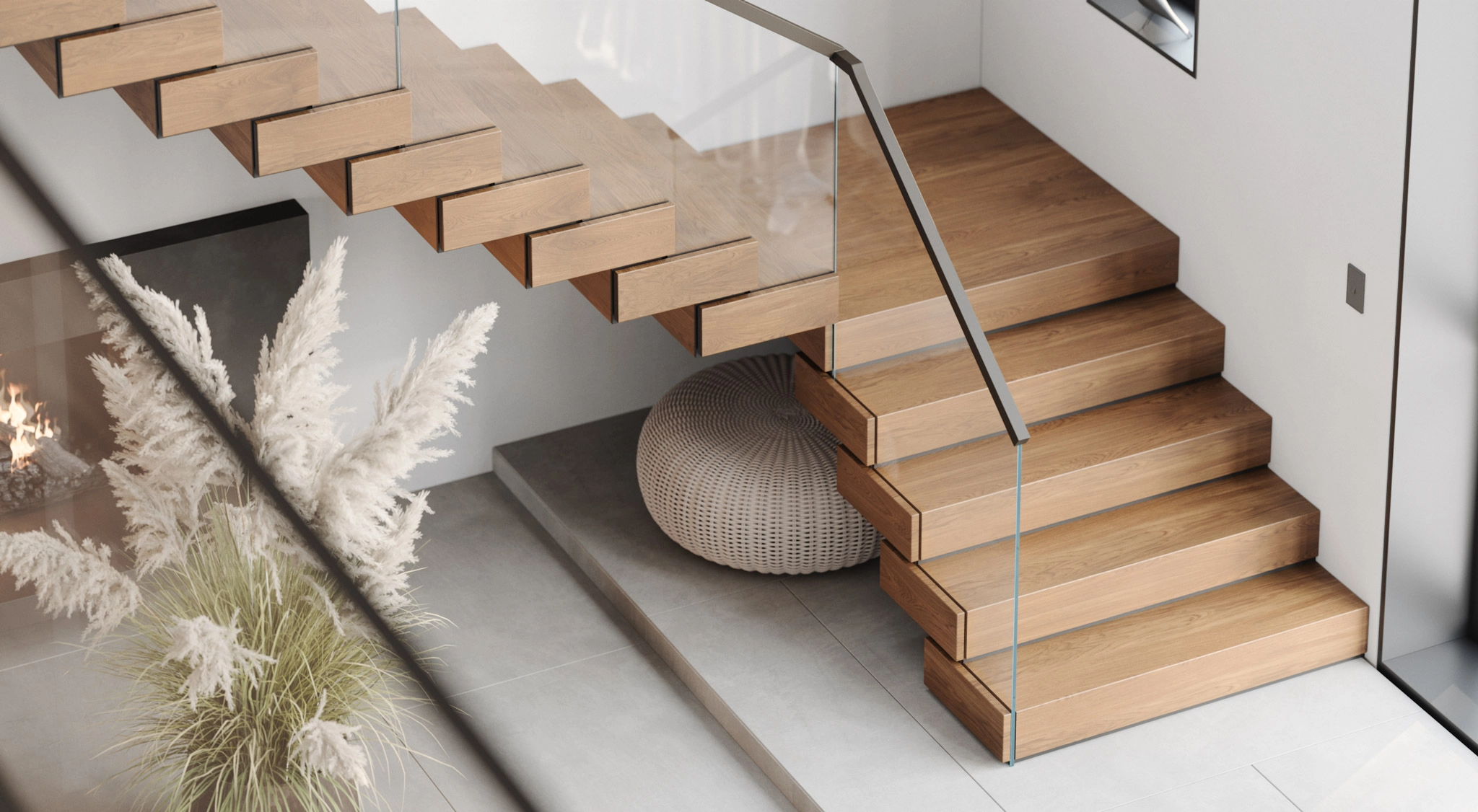Stacked treads and a slim handrail turn a corner beside dried pampas grass