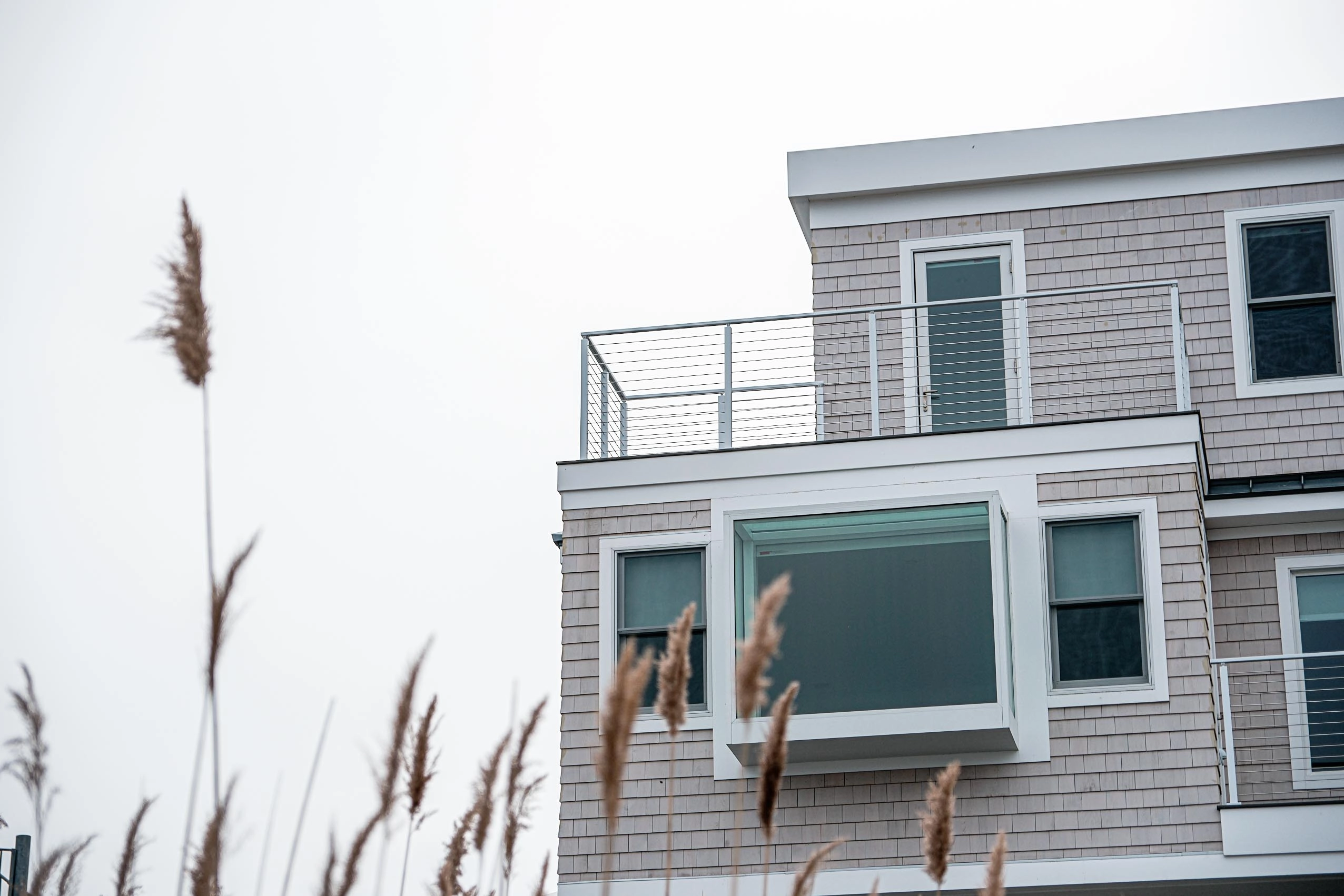 Straight-on view of the rod railing spanning the deck toward open water