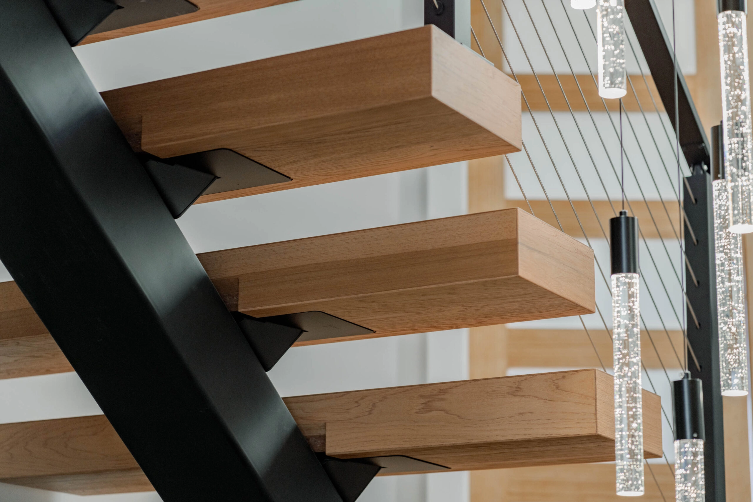 Close view of tread undersides and black mounting brackets on the center stringer