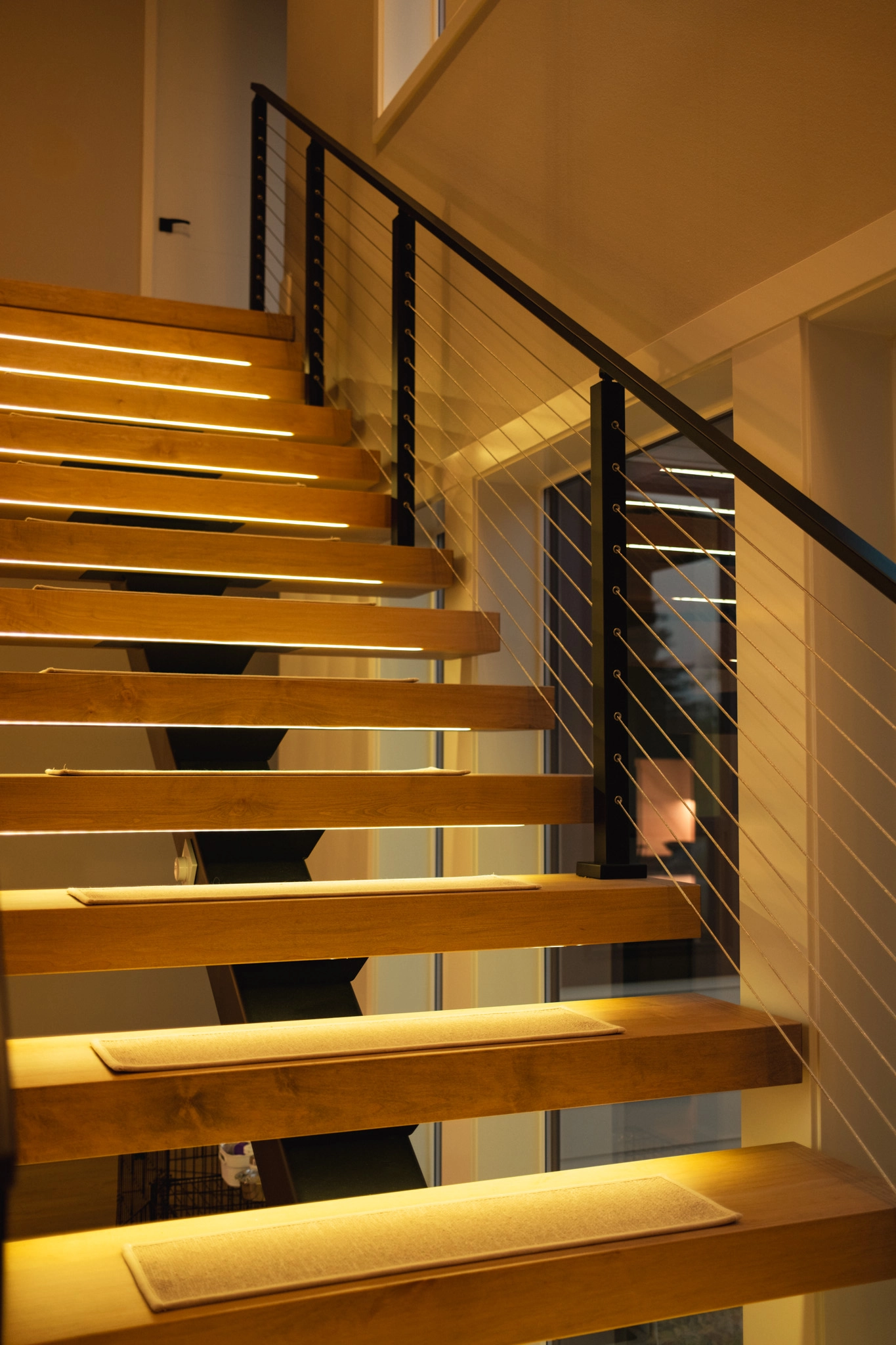 Treads with integrated LEDS cast a soft glow at night on the staircase