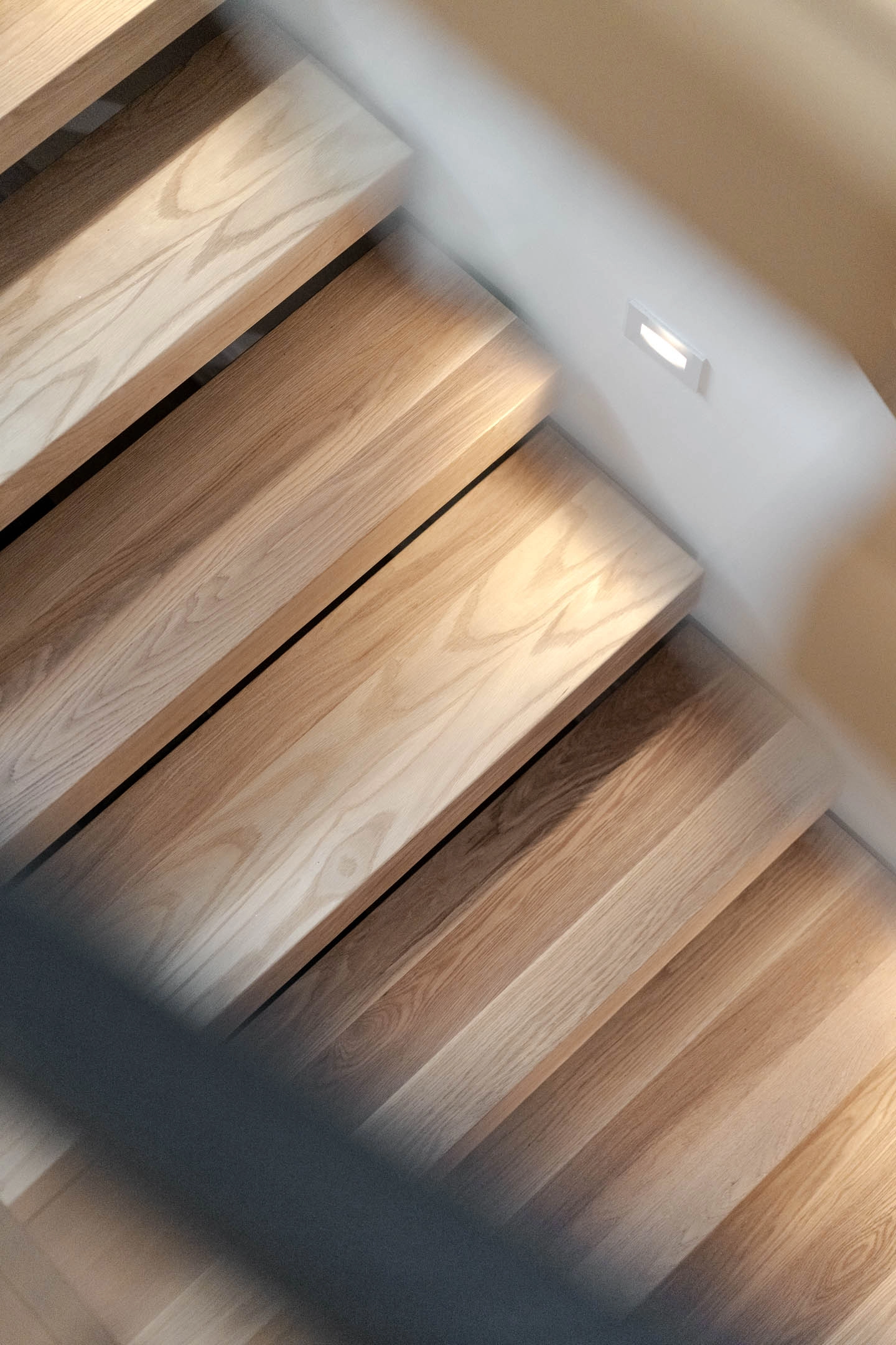 Sunlight falling across the treads seen from above at a sharp angle