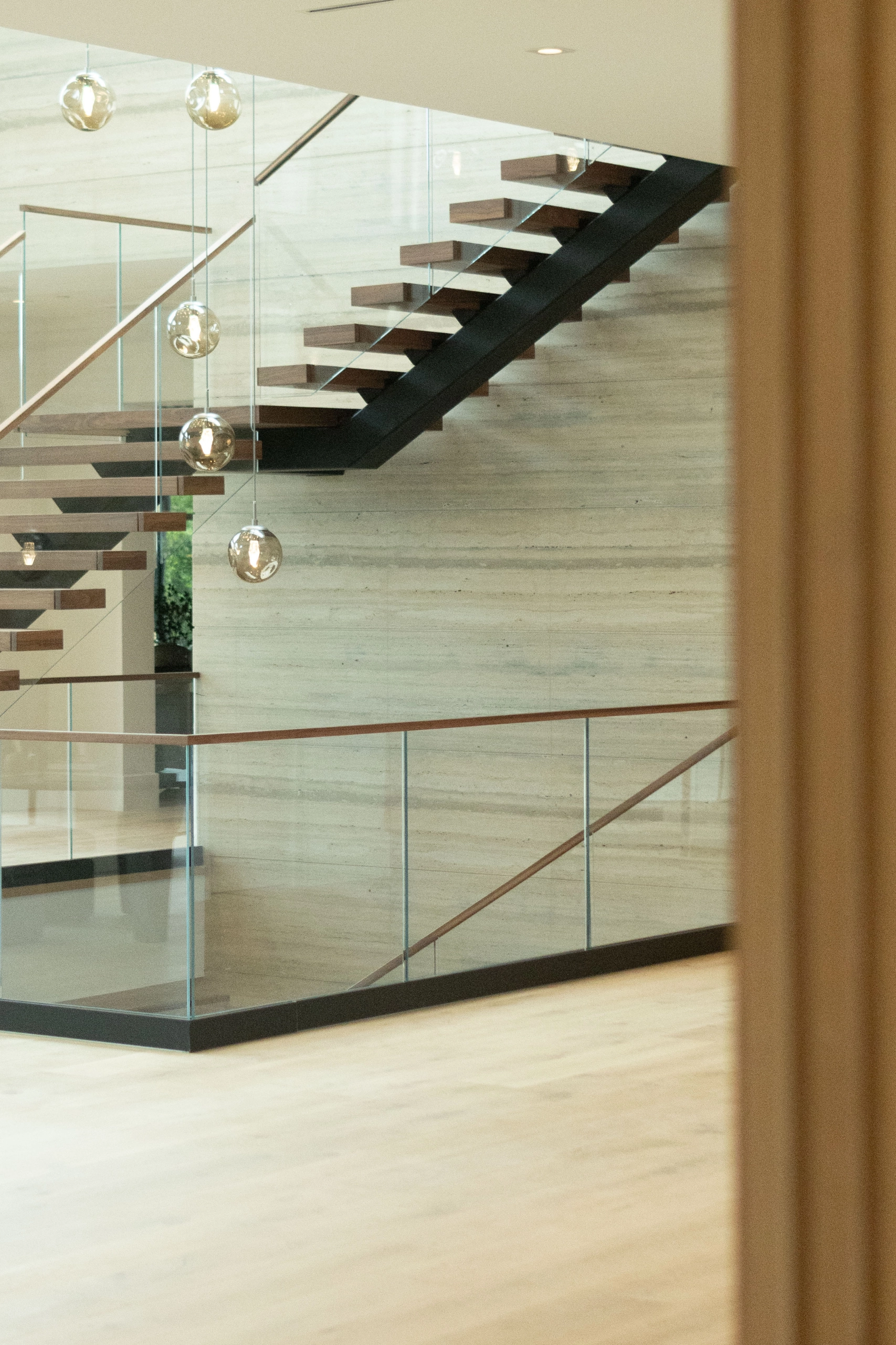 Stair and balcony railing glimpsed past a wall edge from the next room