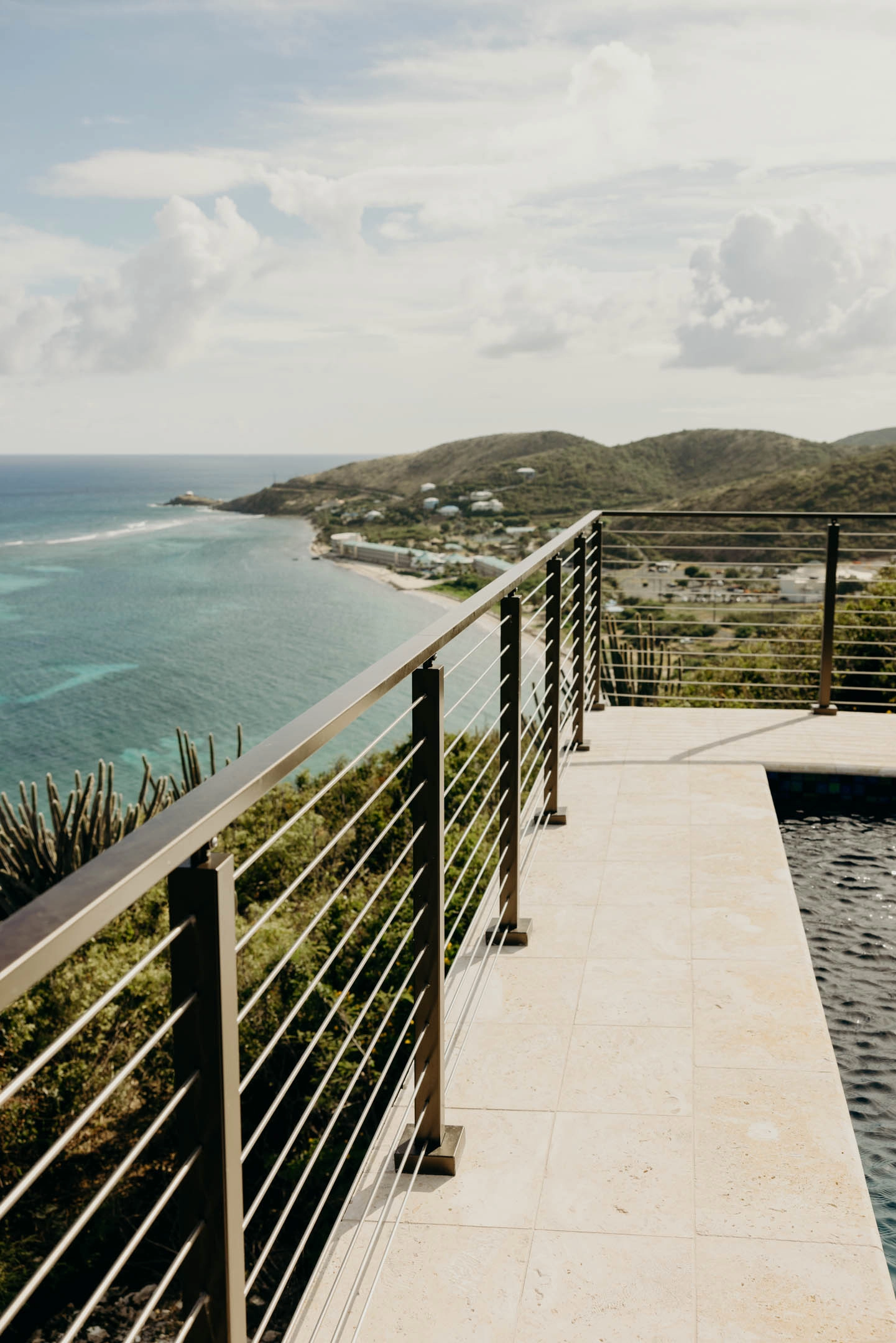 Walkway edged with rod railing following the coastline into the distance