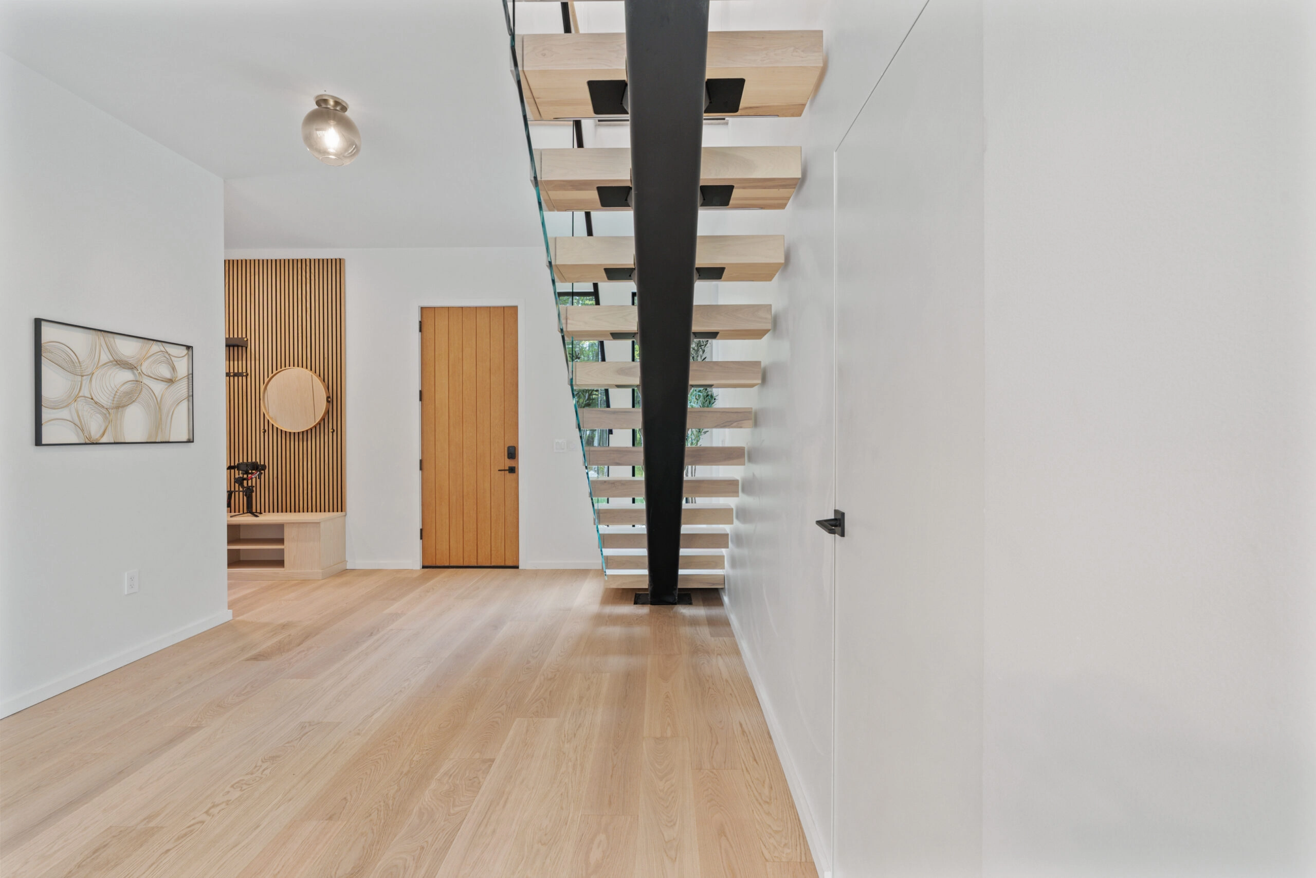 Underside of the floating treads and black center stringer from the hallway