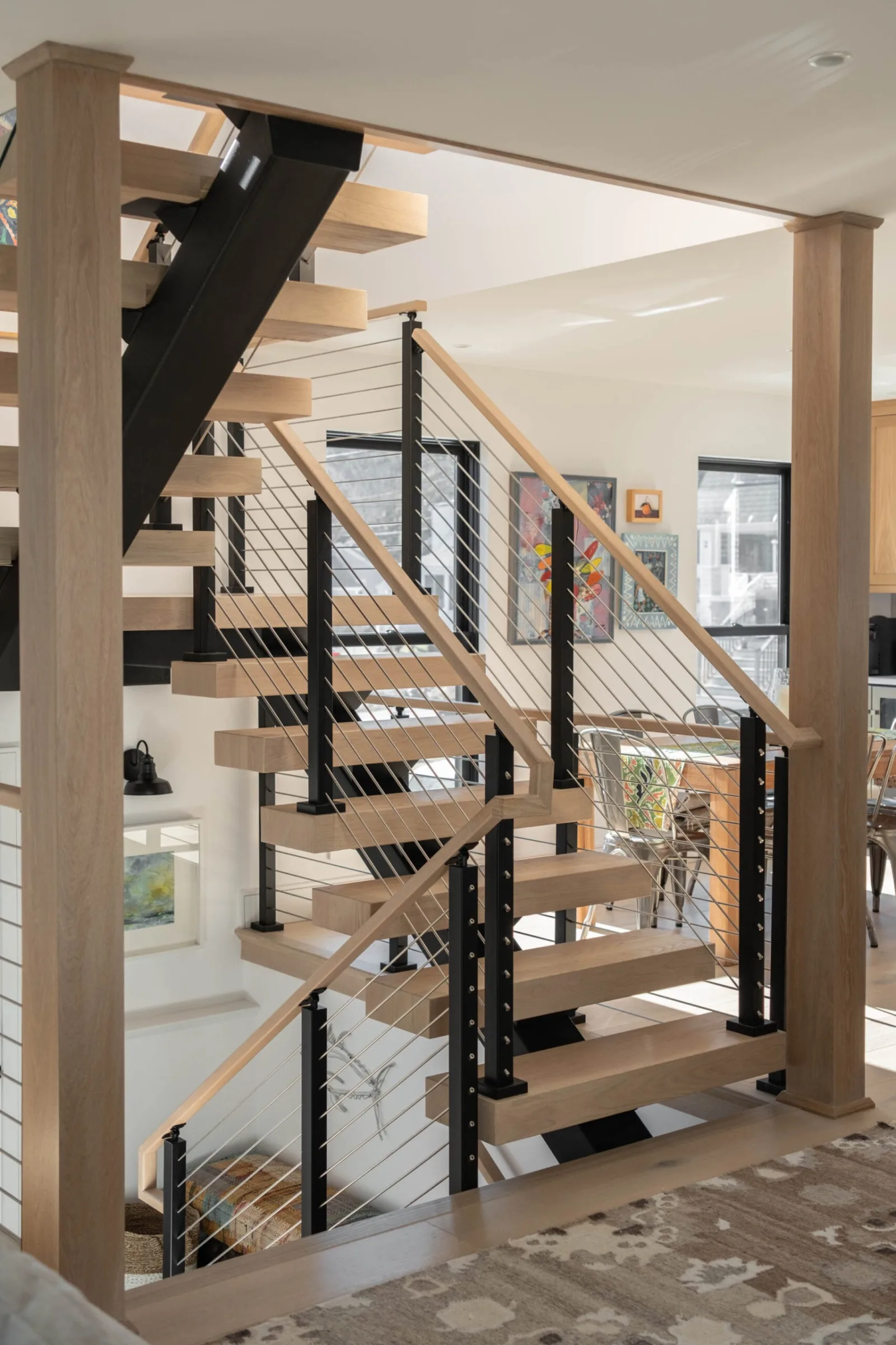 Full stair framed between two wood columns from the main living space