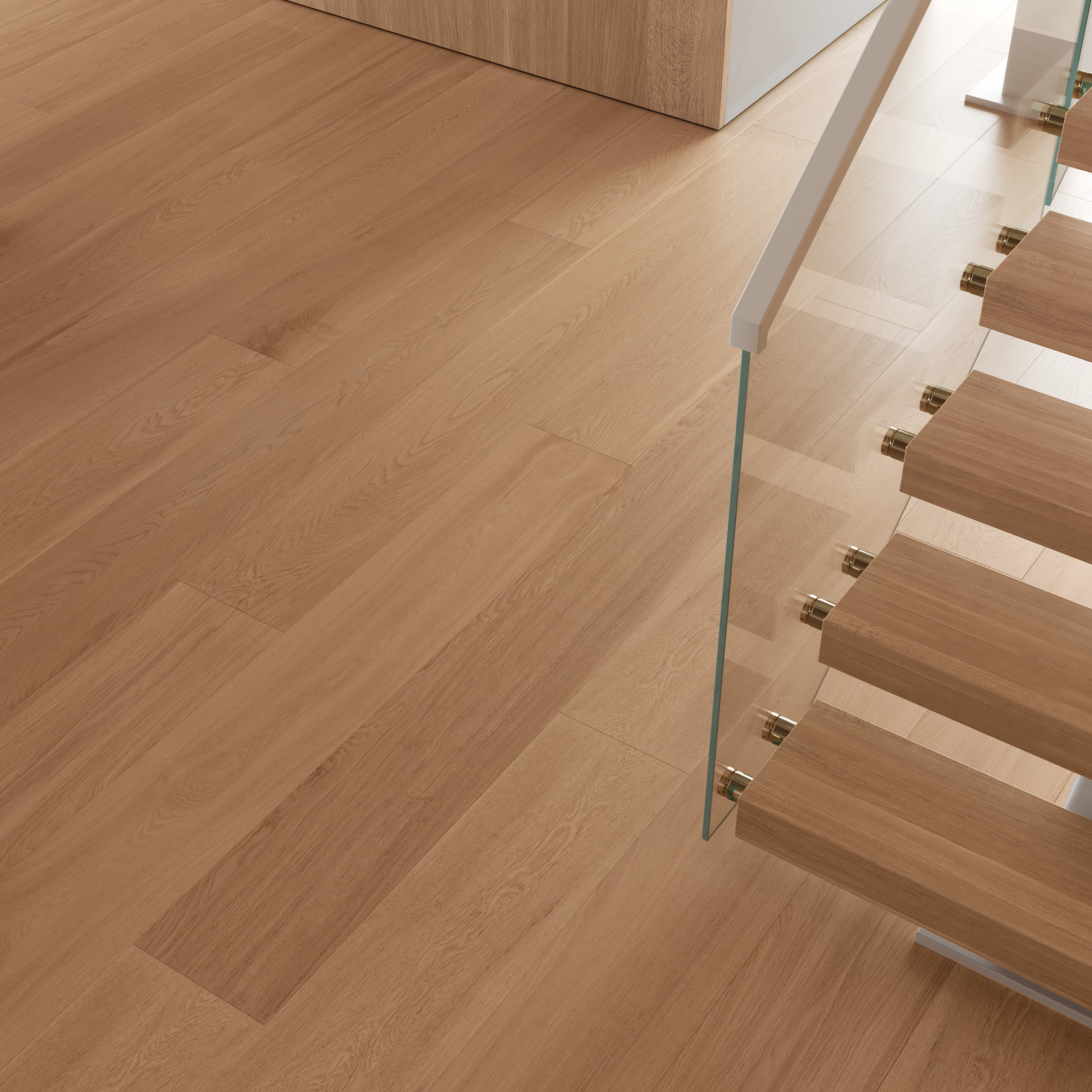 Close look at wide-plank flooring meeting the glass railing base and the lowest floating treads