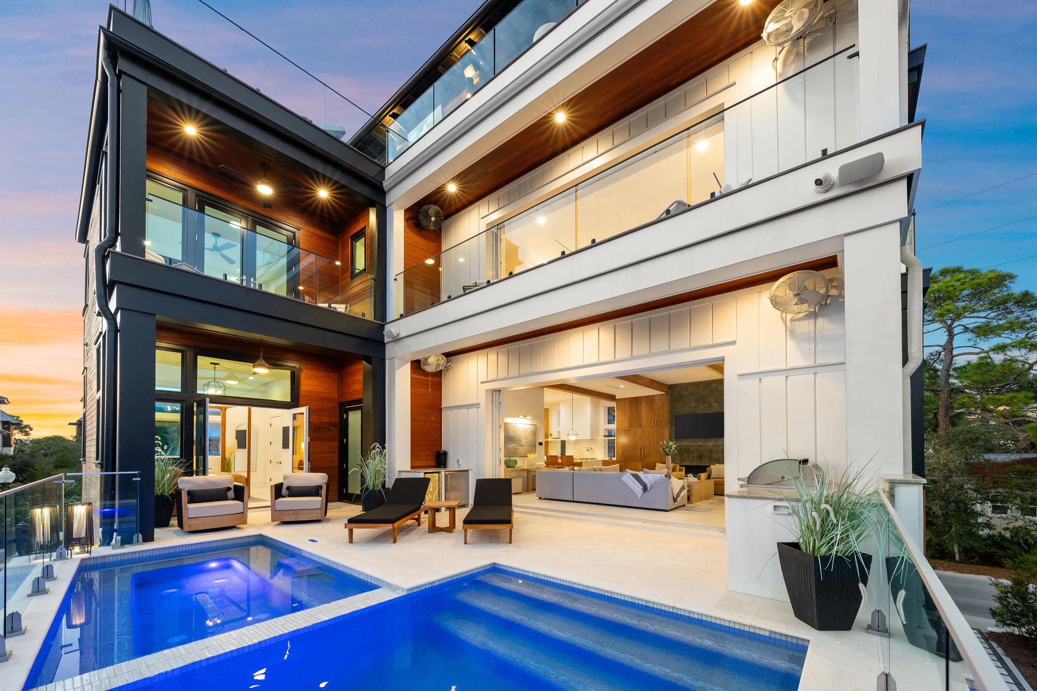 Courtyard pool below stacked balconies with glass and black railing runs