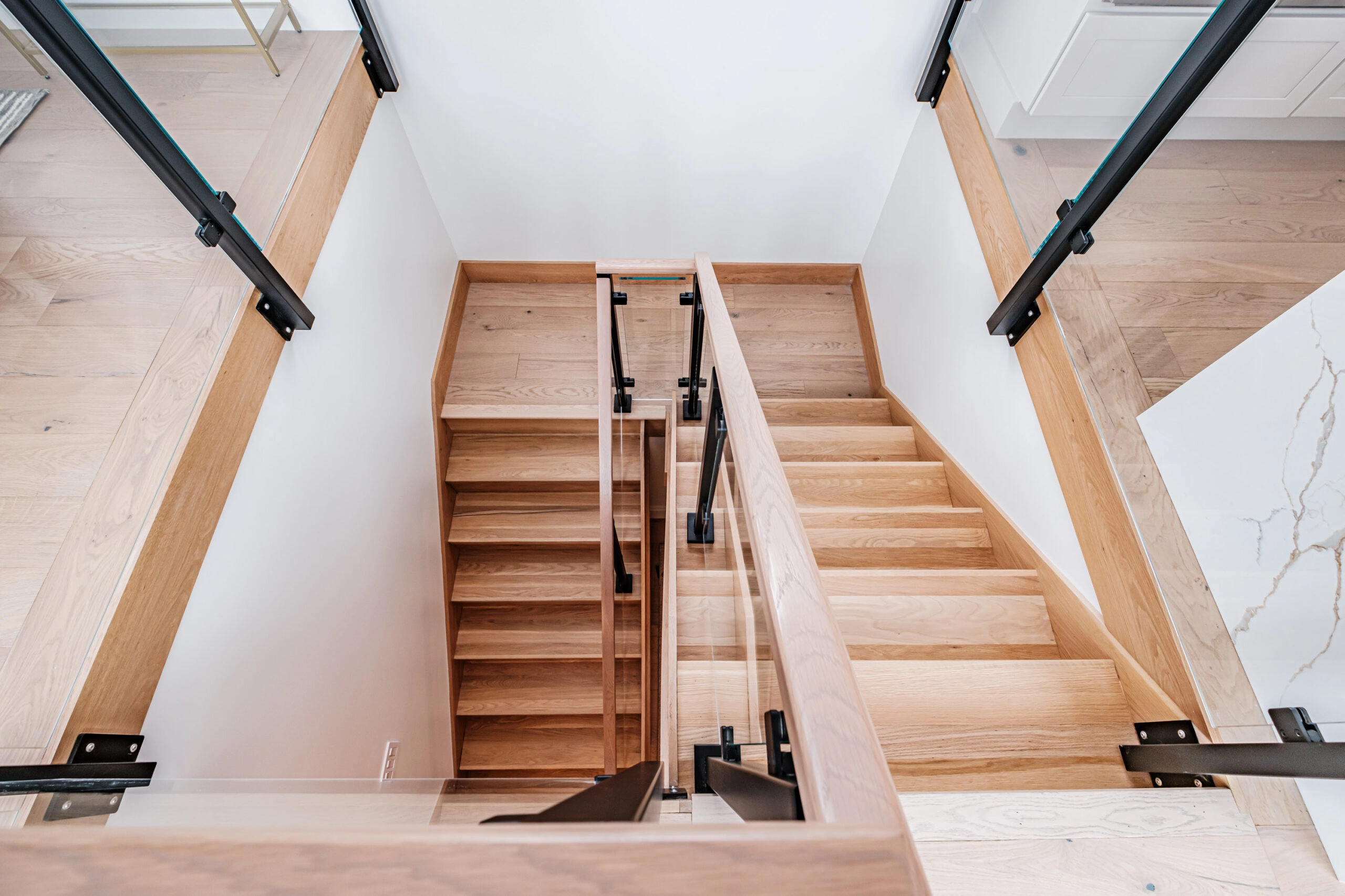 Overhead view of the stair, built-in shelving and railing posts on the landing
