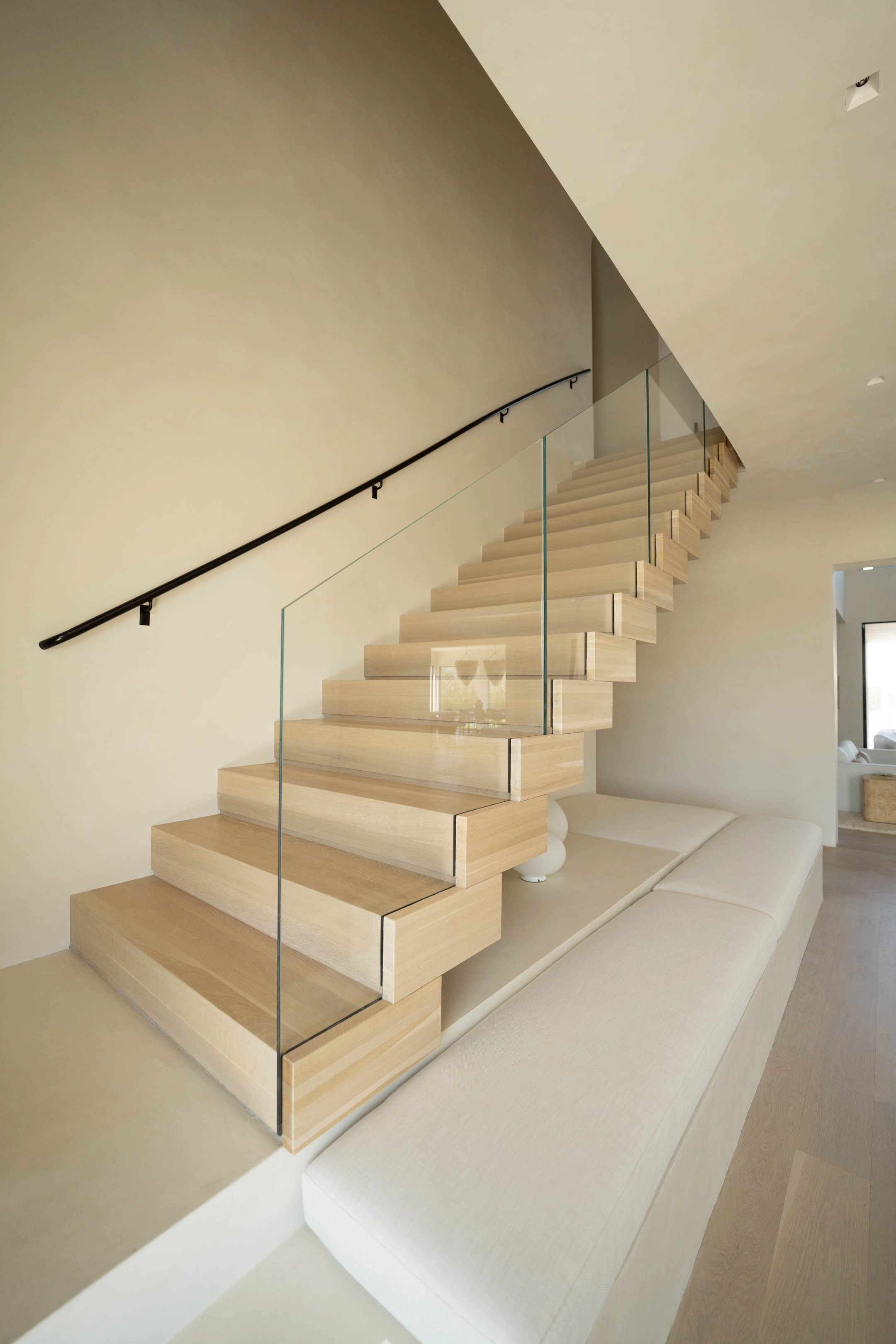 Flight climbing with glass on one flank and a wall-mounted handrail opposite