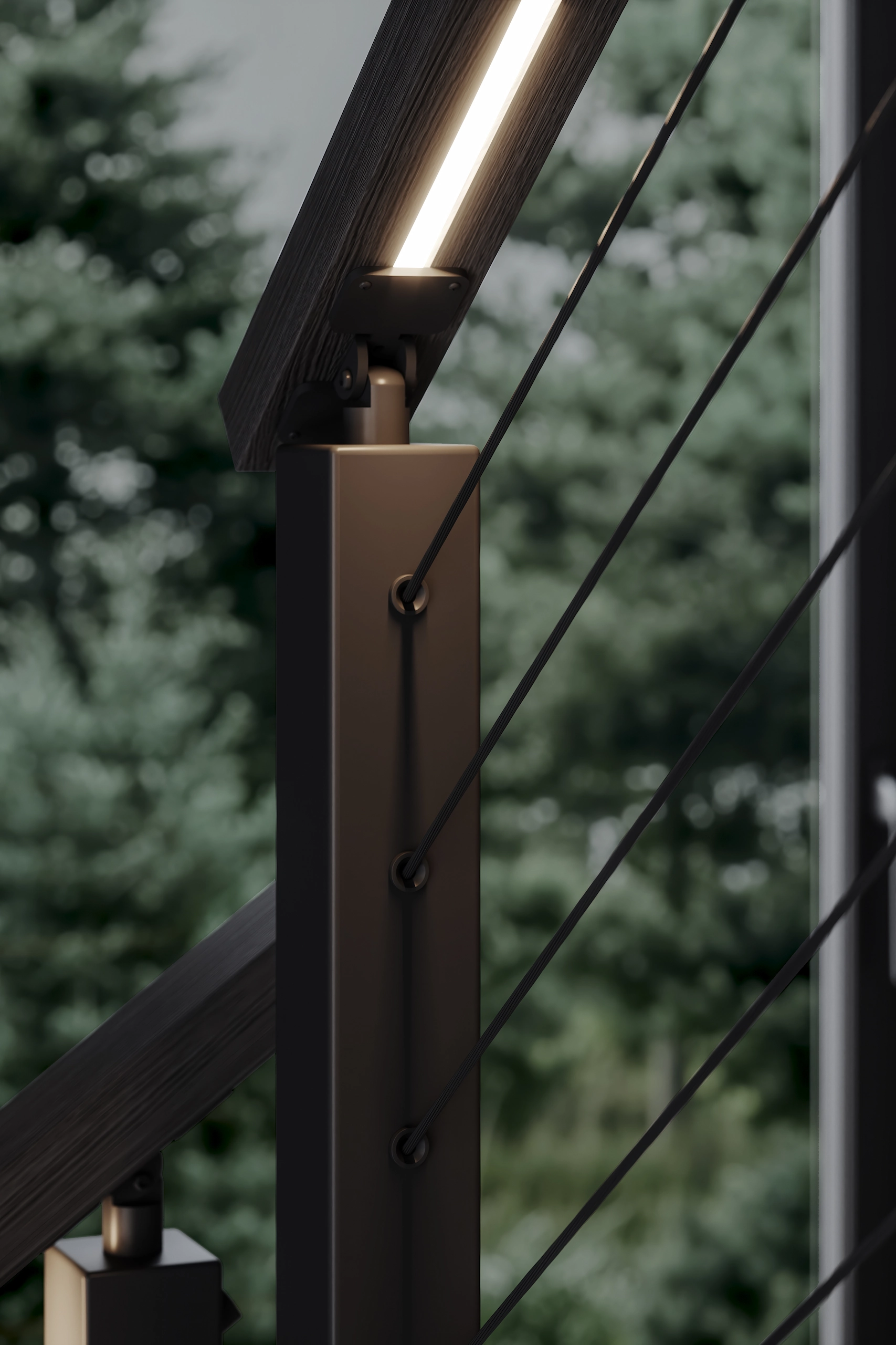 Close view of a post, cable ends and the glowing handrail above